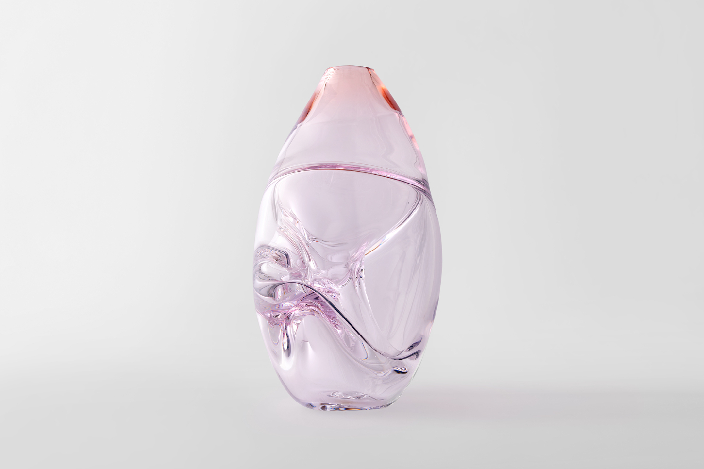 Selected works by Philipp Weber — Hand-blown glass vessel with organic, fluid surface distortions rendered in translucent pink and lavender tones.