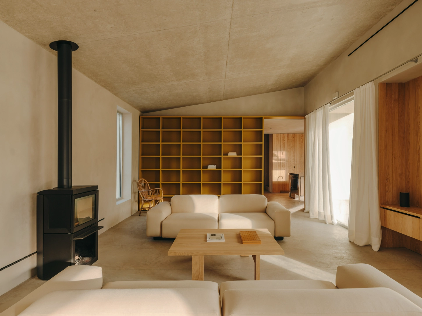 Casa TD by Skye Maunsell, Jordi Veciana and Juan Gurrea Rumeu — The living room establishes a measured domestic landscape through layered material contrasts.