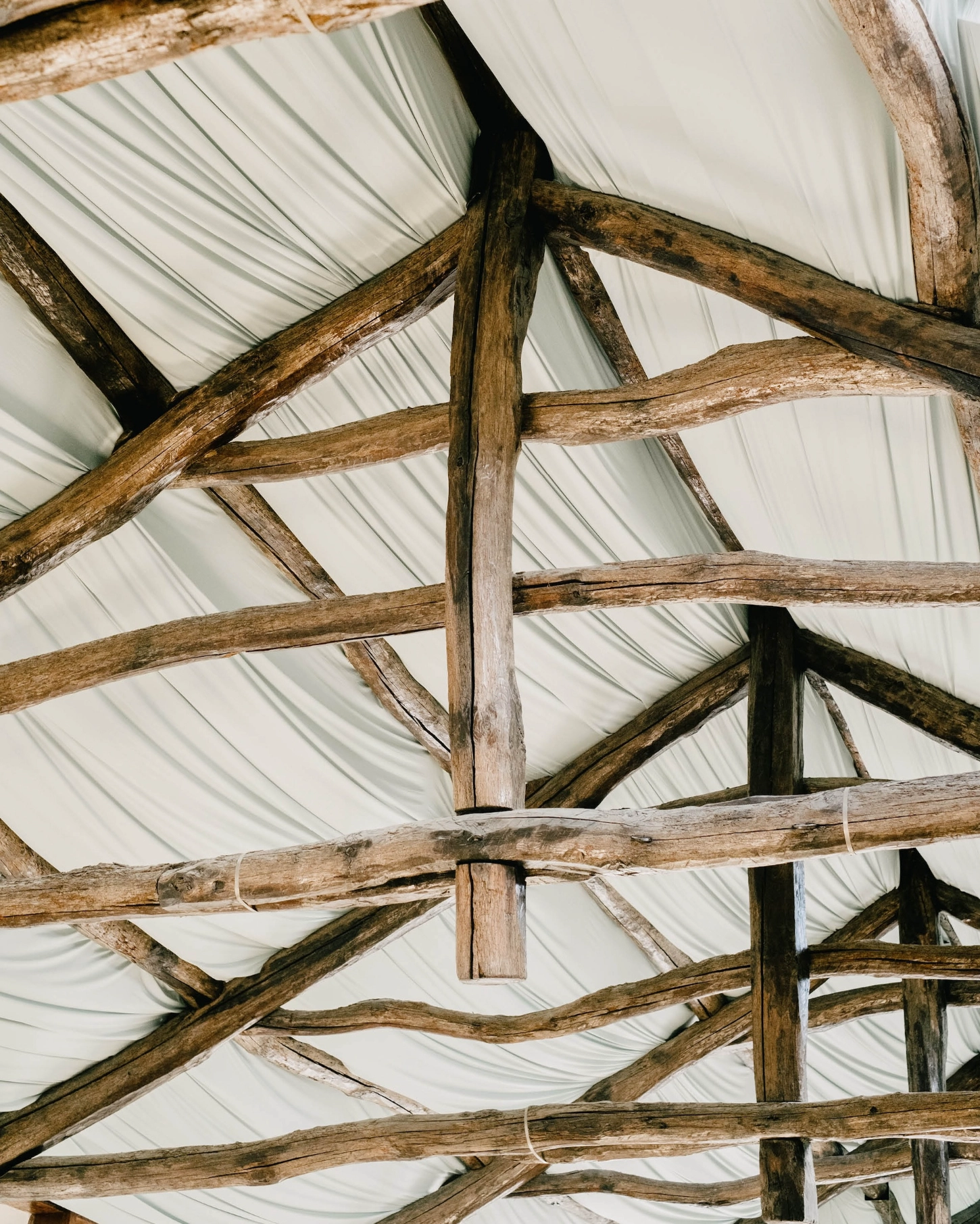 'House with many faces' by Fala Atelier — Overhead view of the interior roof structure reveals the project's post-and-beam construction logic.