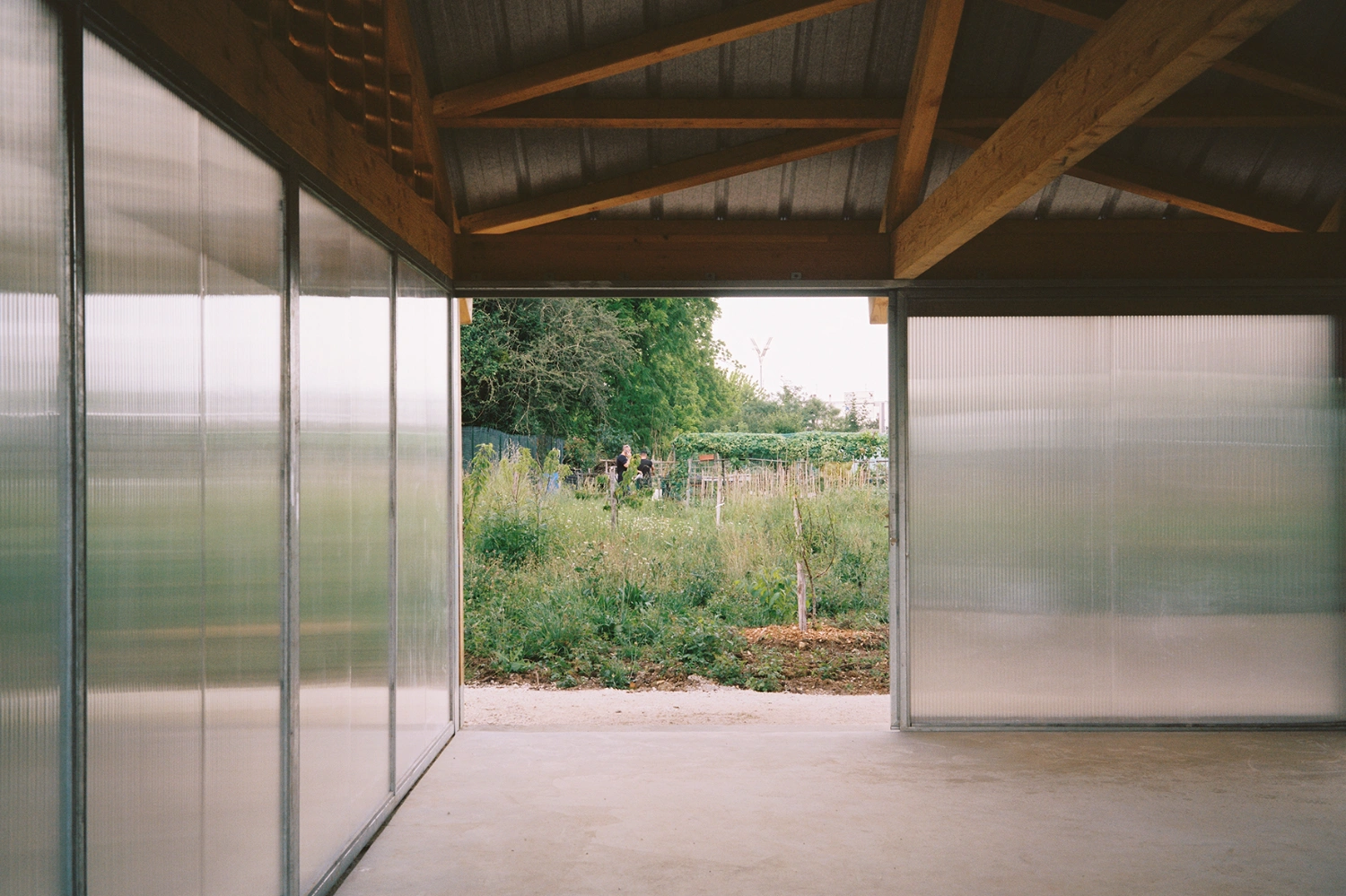 Garden Pavilion by Esnard Sanz Architectes — The pavilion's interior frames a verdant allotment garden through continuous glazing.
