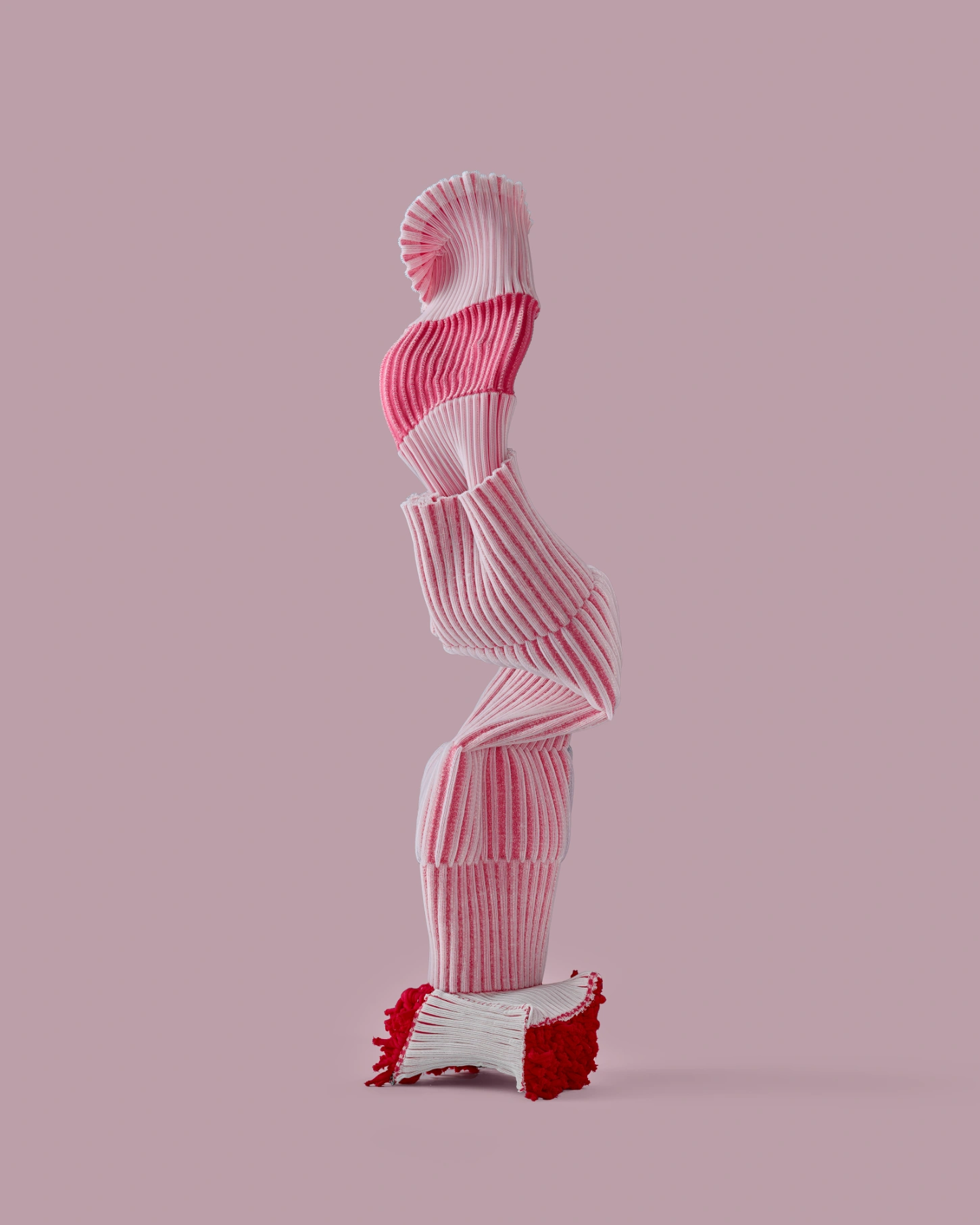 PINKDOM by Knit Pigment — A stacked sculptural form constructed from ribbed textile or knit material in graduated pink tones, from pale blush at the apex to deep crimson at the base.