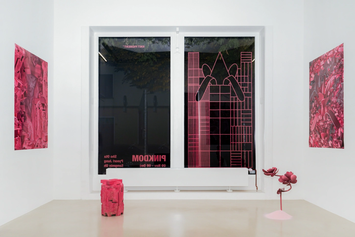 PINKDOM by Knit Pigment — Installation view of PINKDOM featuring carved wooden sculptural forms rendered entirely in hot pink, creating a monochromatic visual field.