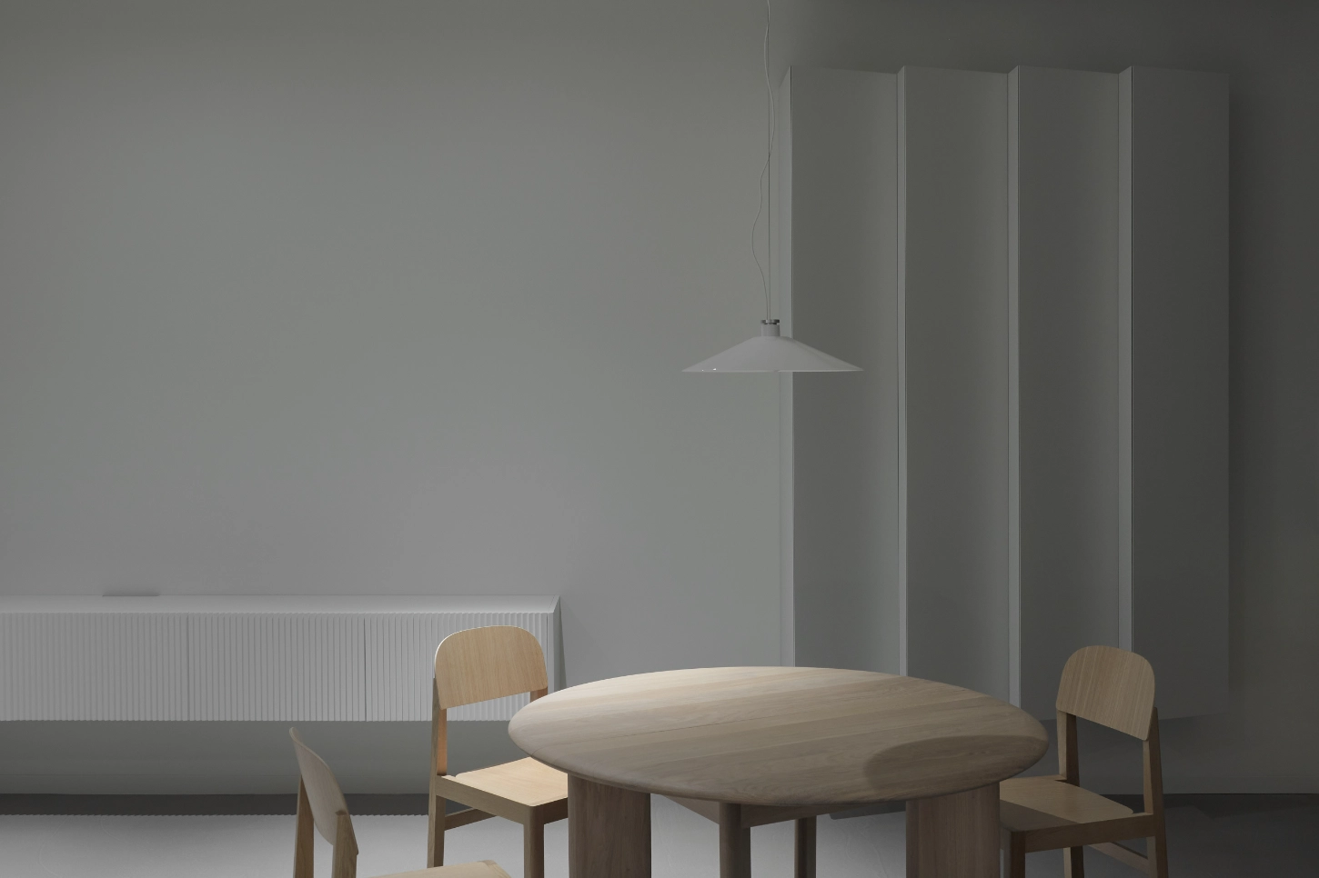 VVV by i.B Archstudio — A dining moment captured in studied minimalism: an oval timber table anchors the composition, surrounded by three wooden chairs with simple curved backs.