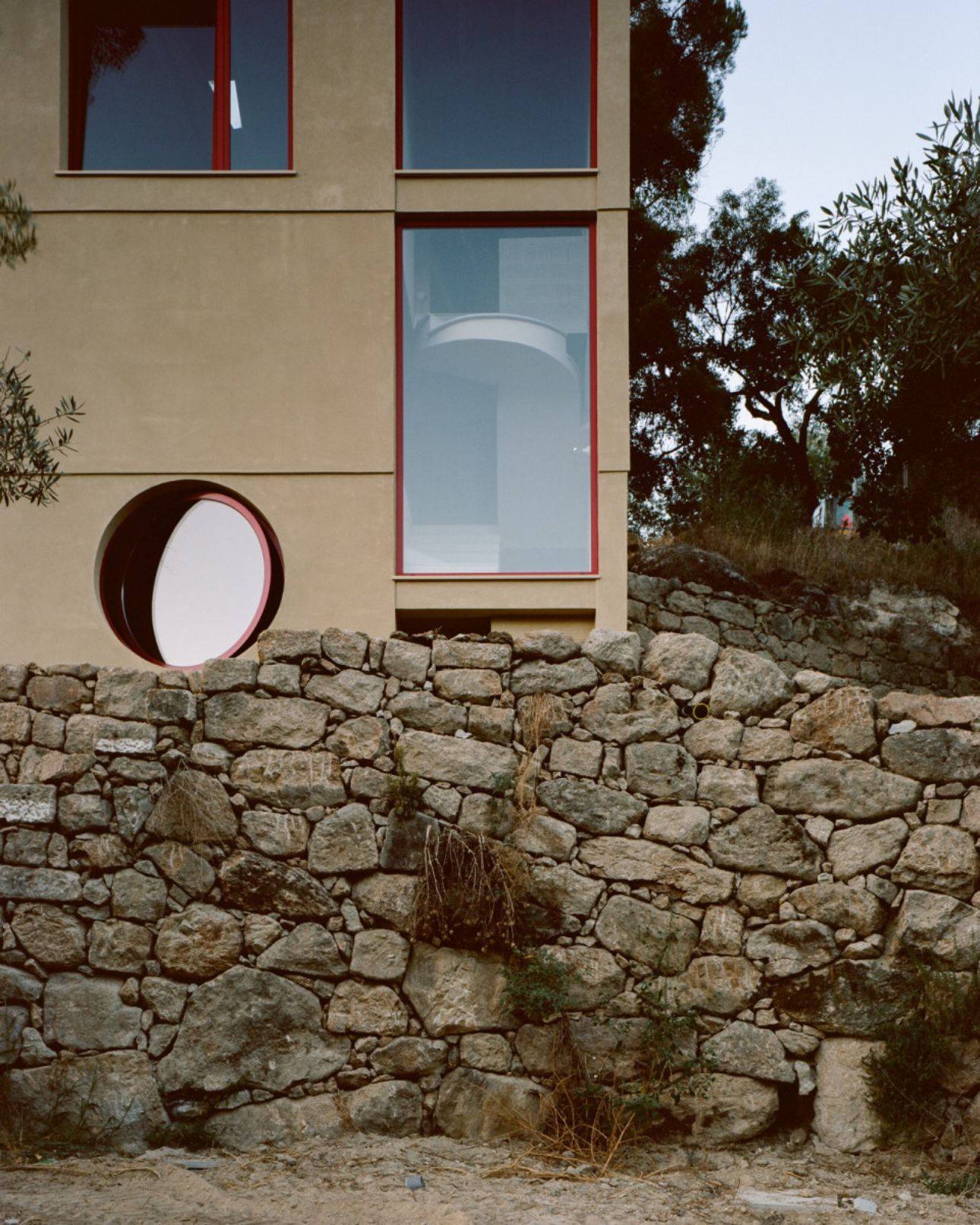 House in Ancede by atelier local — The façade of House in Ancede demonstrates a deliberate material contrast between contemporary and vernacular construction.
