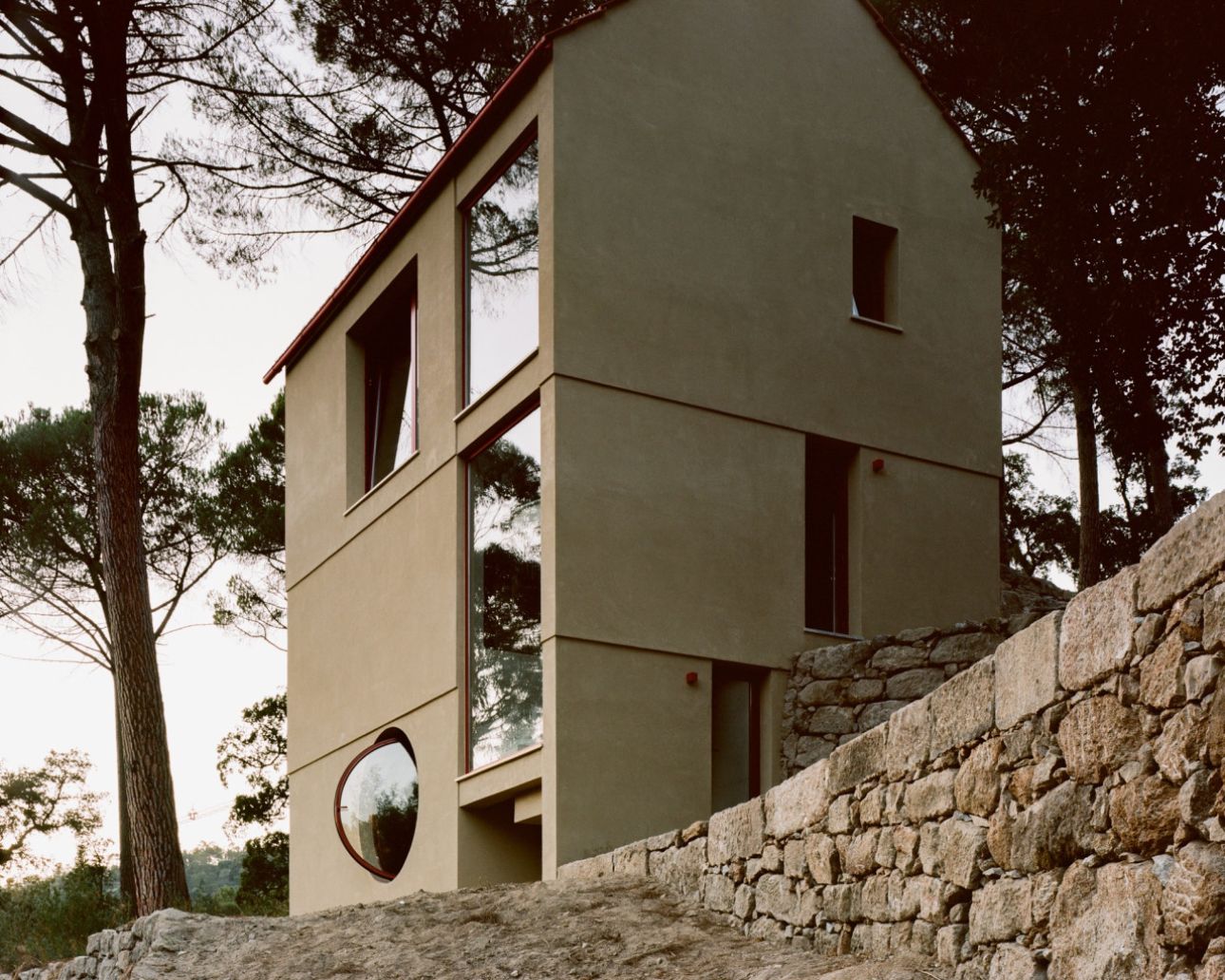 House in Ancede by atelier local — House in Ancede presents its entrance facade as a studied composition of material contrasts.