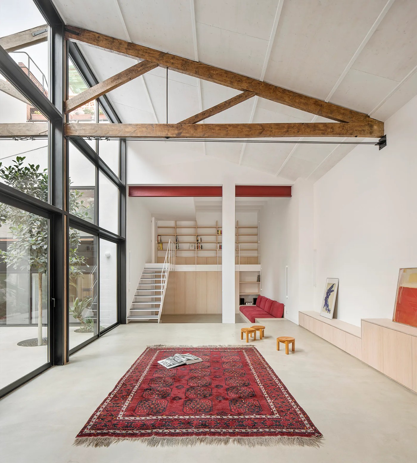 Red House by Aramé Studio — A converted Poblenou factory floor demonstrates post-industrial domestication through material restraint.