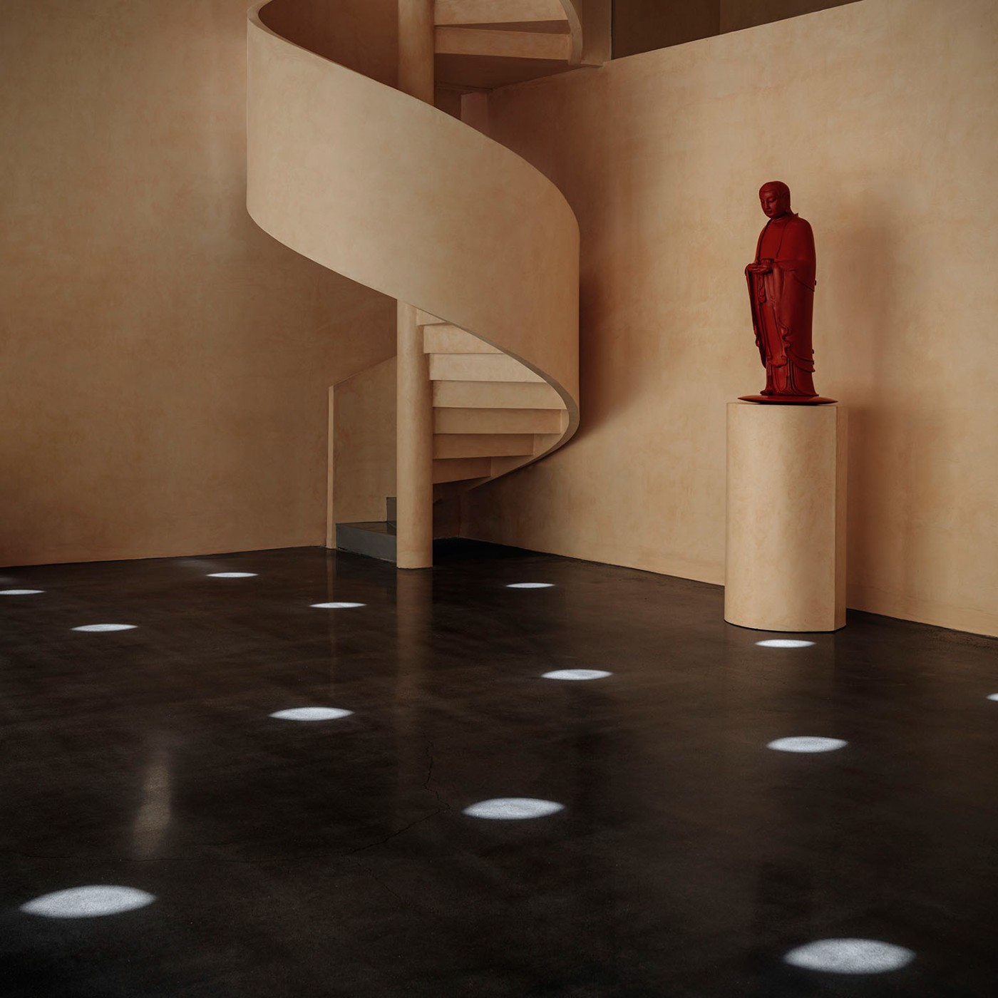 'The Field' by TEAM_BLDG by TEAM BLDG — A rendered interior volume housing a red sculptural figure on a cylindrical plinth.