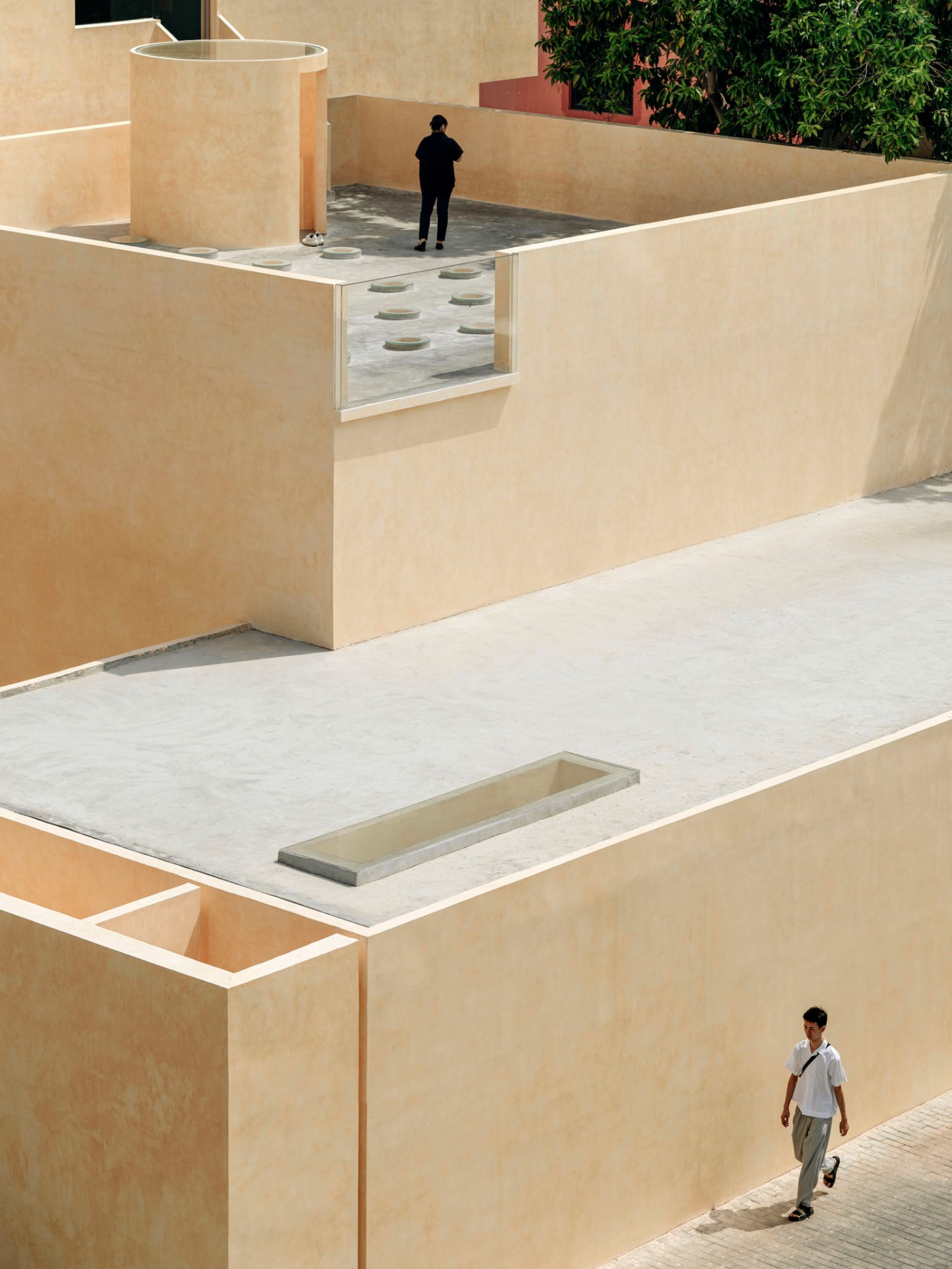 'The Field' by TEAM_BLDG by TEAM BLDG — The photograph captures a multi-level courtyard void within the renovated studio, emphasizing spatial compression and release through stacked horizontal...