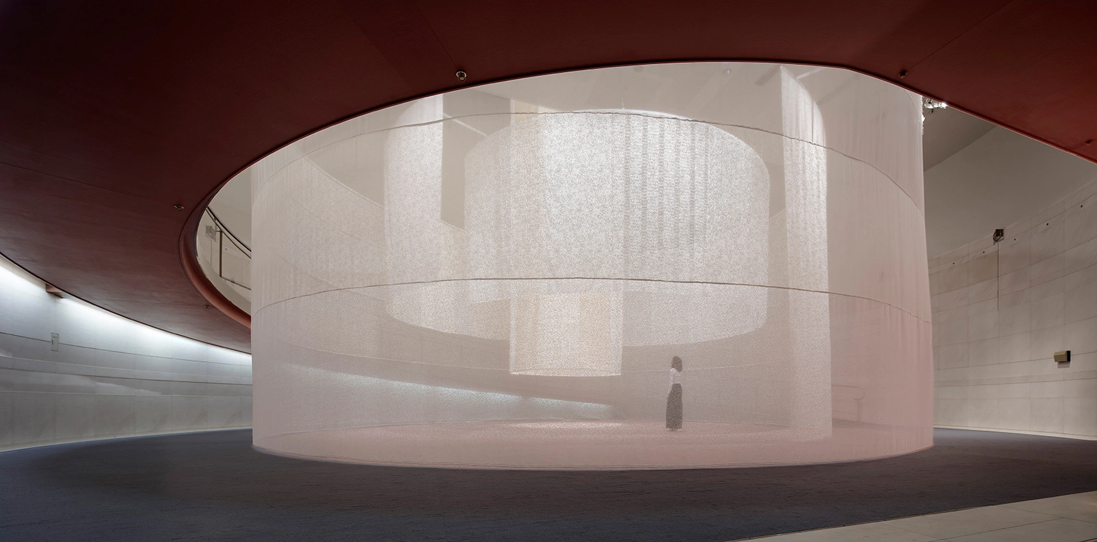 Three Tones at Spiral Garden by Isaku Design + Tashiro Design — A cylindrical textile installation occupies the center of Spiral Garden's curved gallery space.