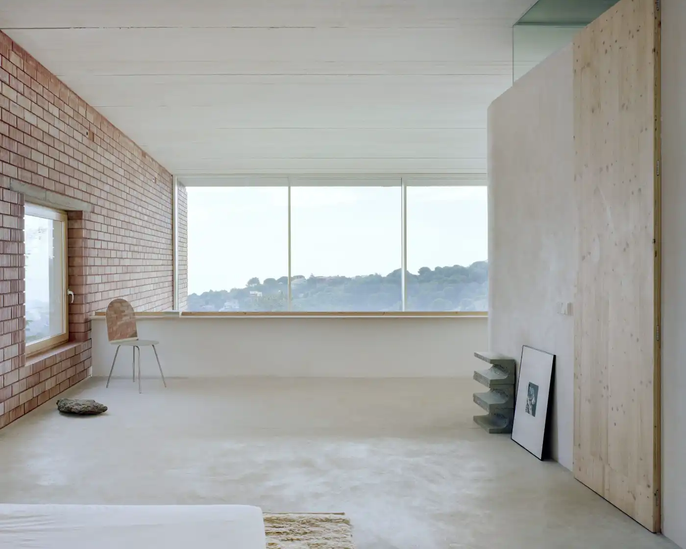 Casa Dosmurs by MESURA — An unfinished interior space captures the project's relationship between enclosure and landscape.