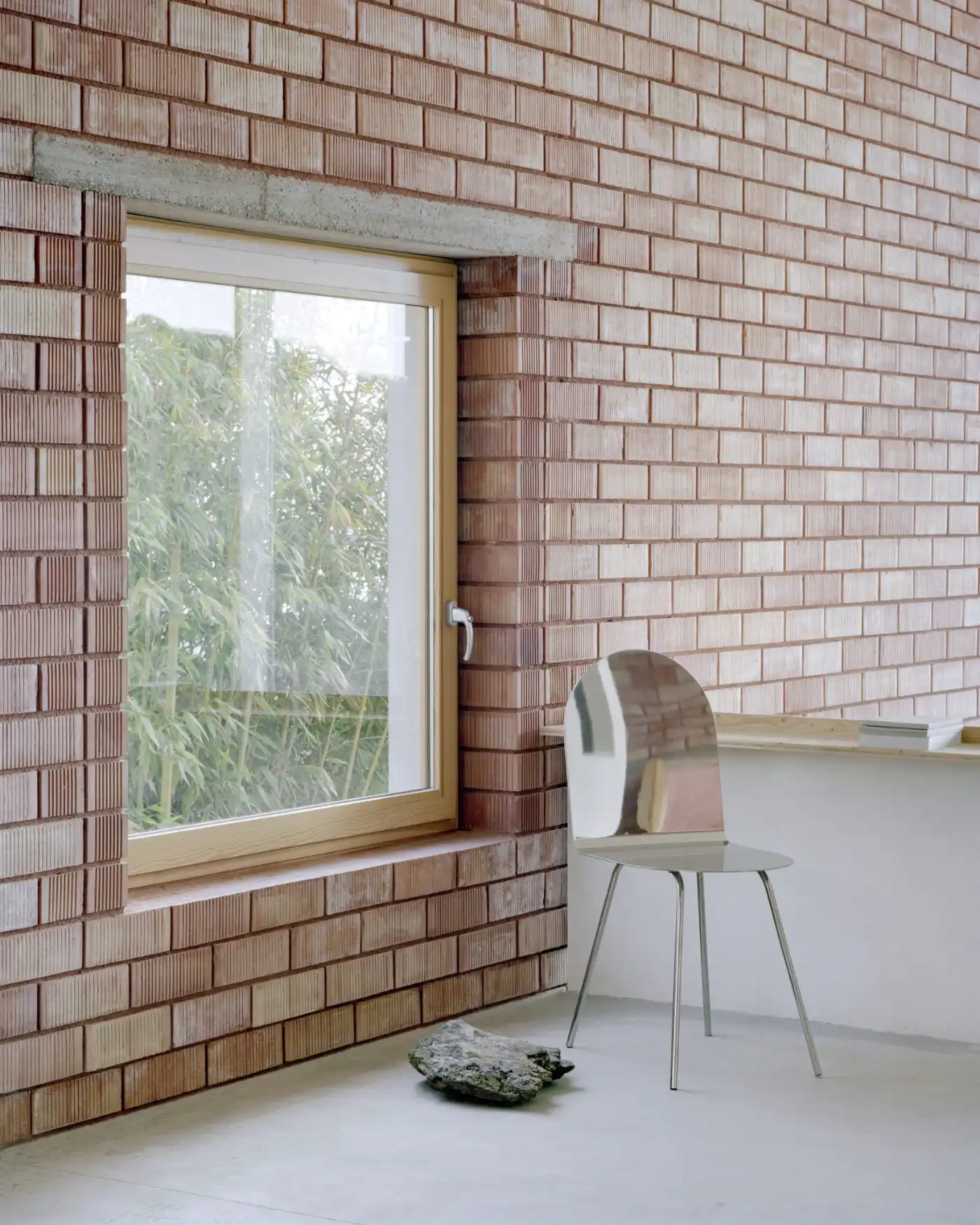Casa Dosmurs by MESURA — Interior threshold space within Casa Dosmurs, framing the relationship between brick envelope and glazed aperture.