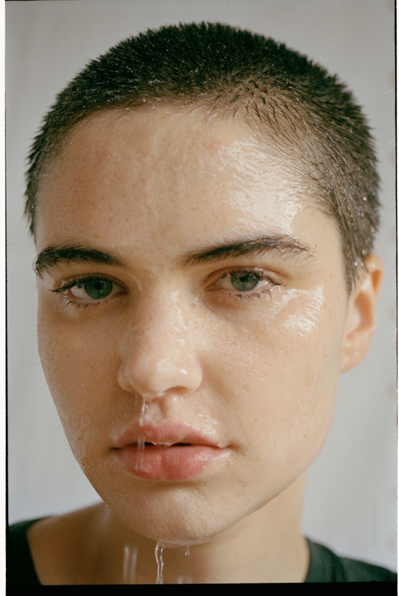 Visitors+ by Piczo — Close-up portrait photograph shot against a neutral gray background.
