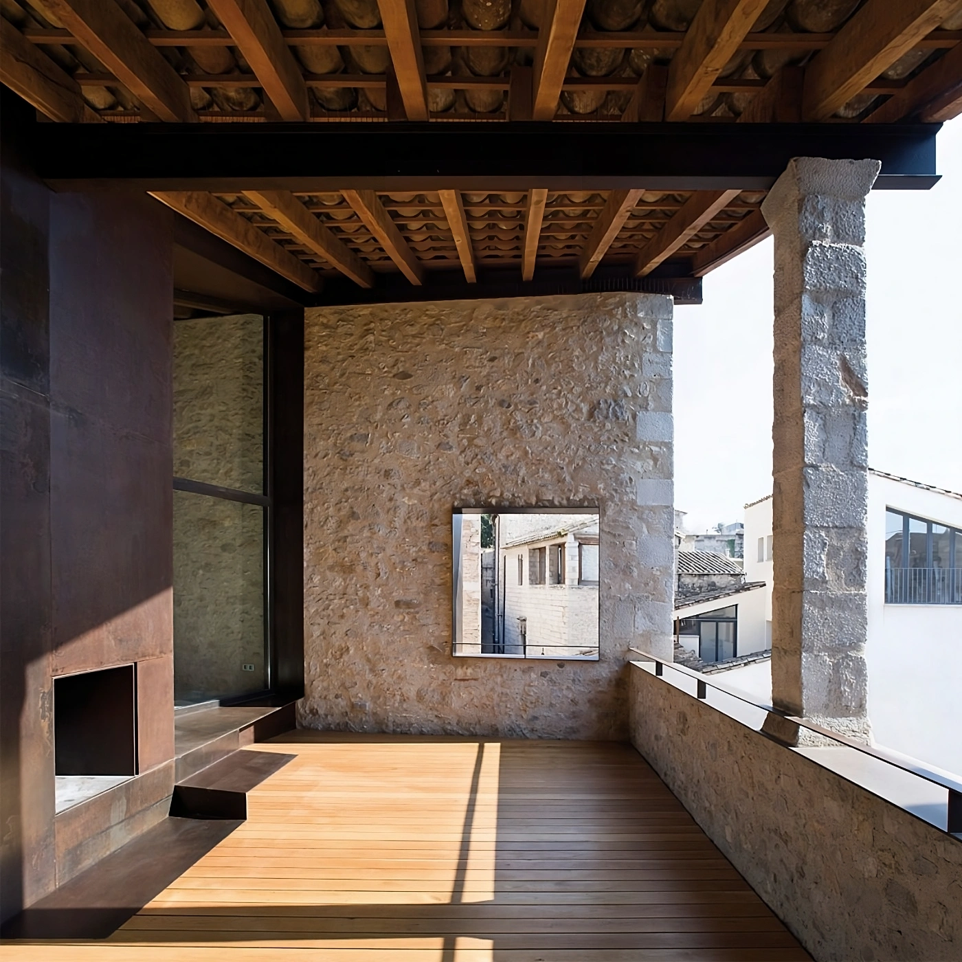 Alemenys 5 by Anna Noguera — A restored rooftop terrace in Girona employs post-and-beam timber construction with ornamental carved soffit details.
