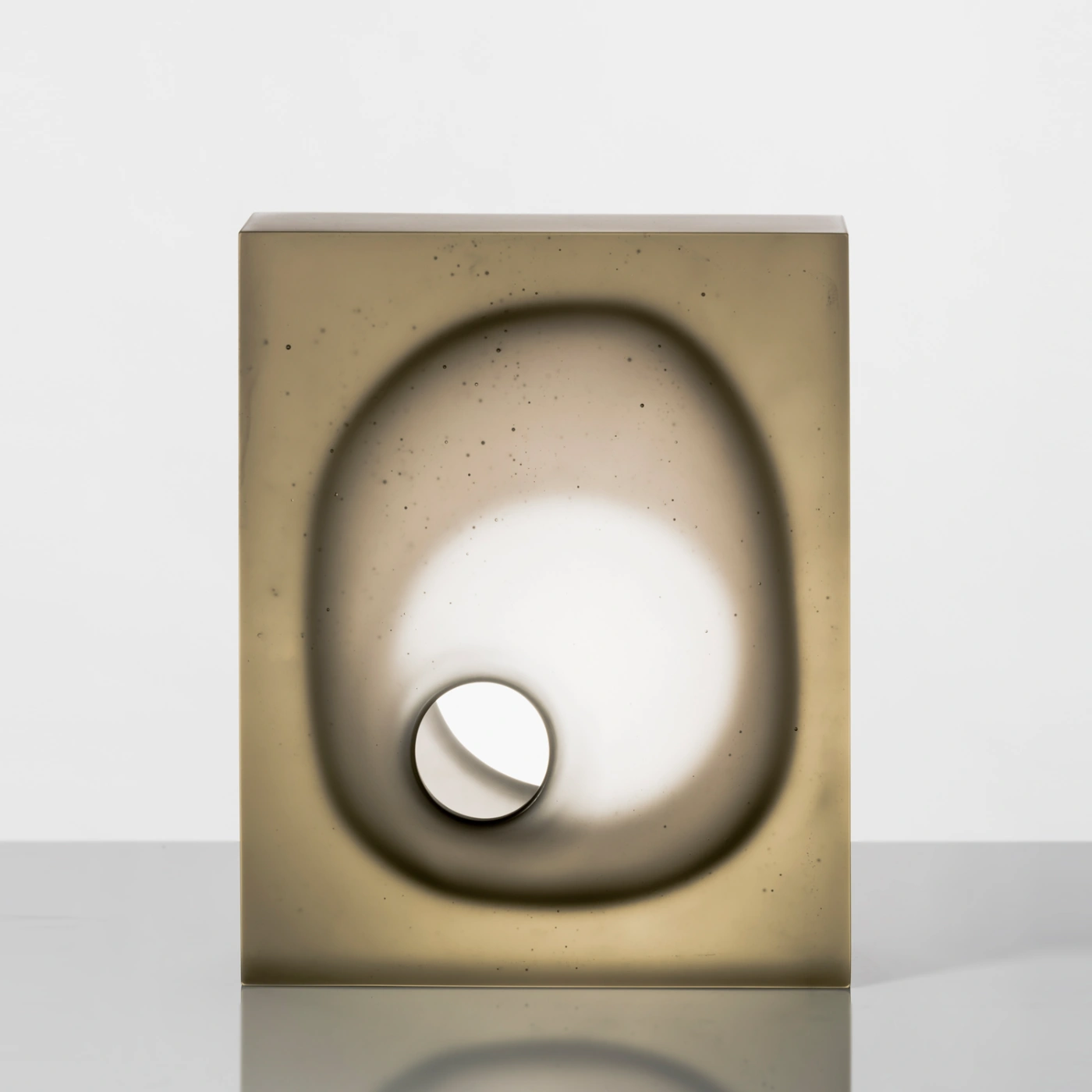 Illumine by Richard Whiteley — A rectangular cast glass vessel with internal void structure dominating the composition.