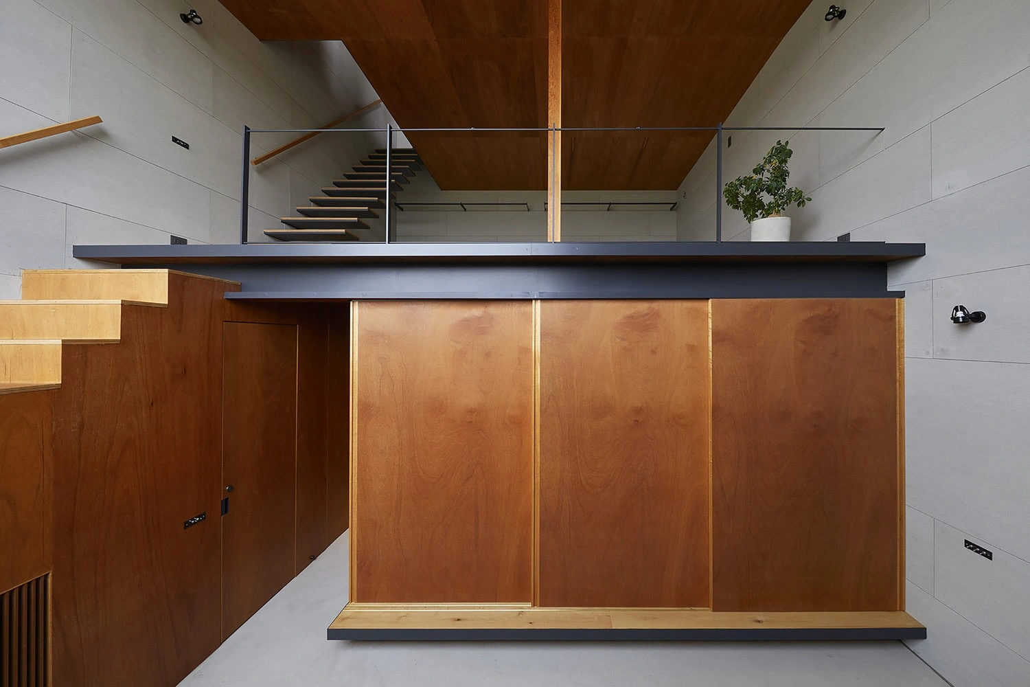 House in Gamo by Suppose Design Studio — An overhead view of a double-height interior volume reveals the architectural hierarchy within House in Gamo.
