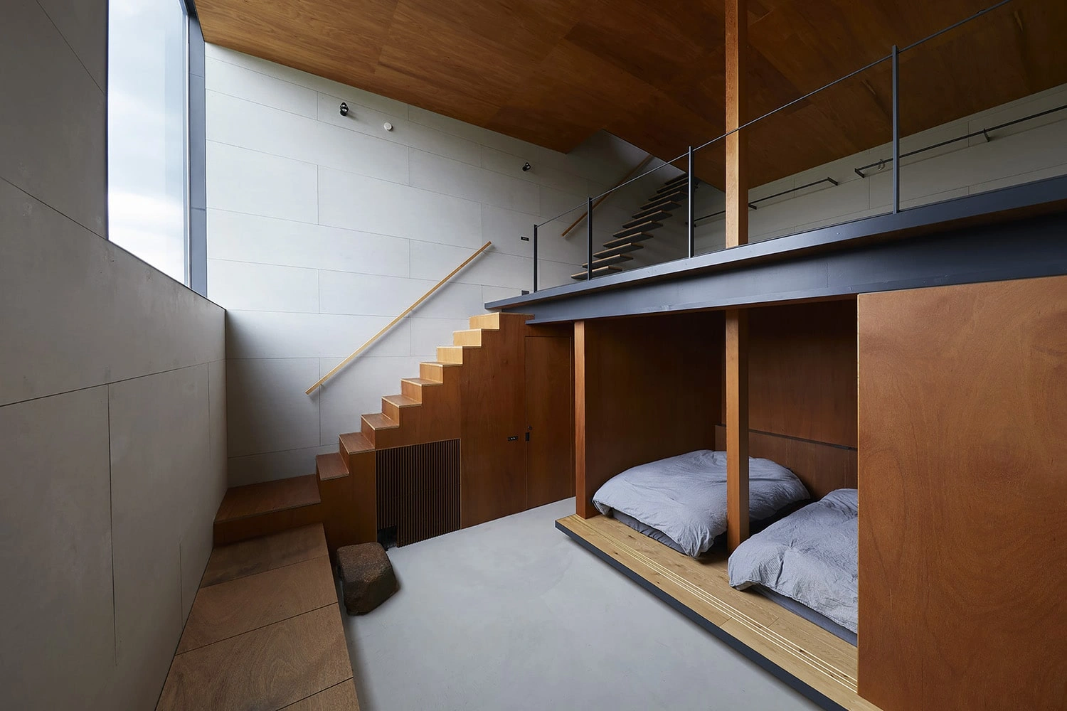House in Gamo by Suppose Design Studio — A multi-level bedroom interior reveals the spatial complexity concealed within House in Gamo's restrained facade.