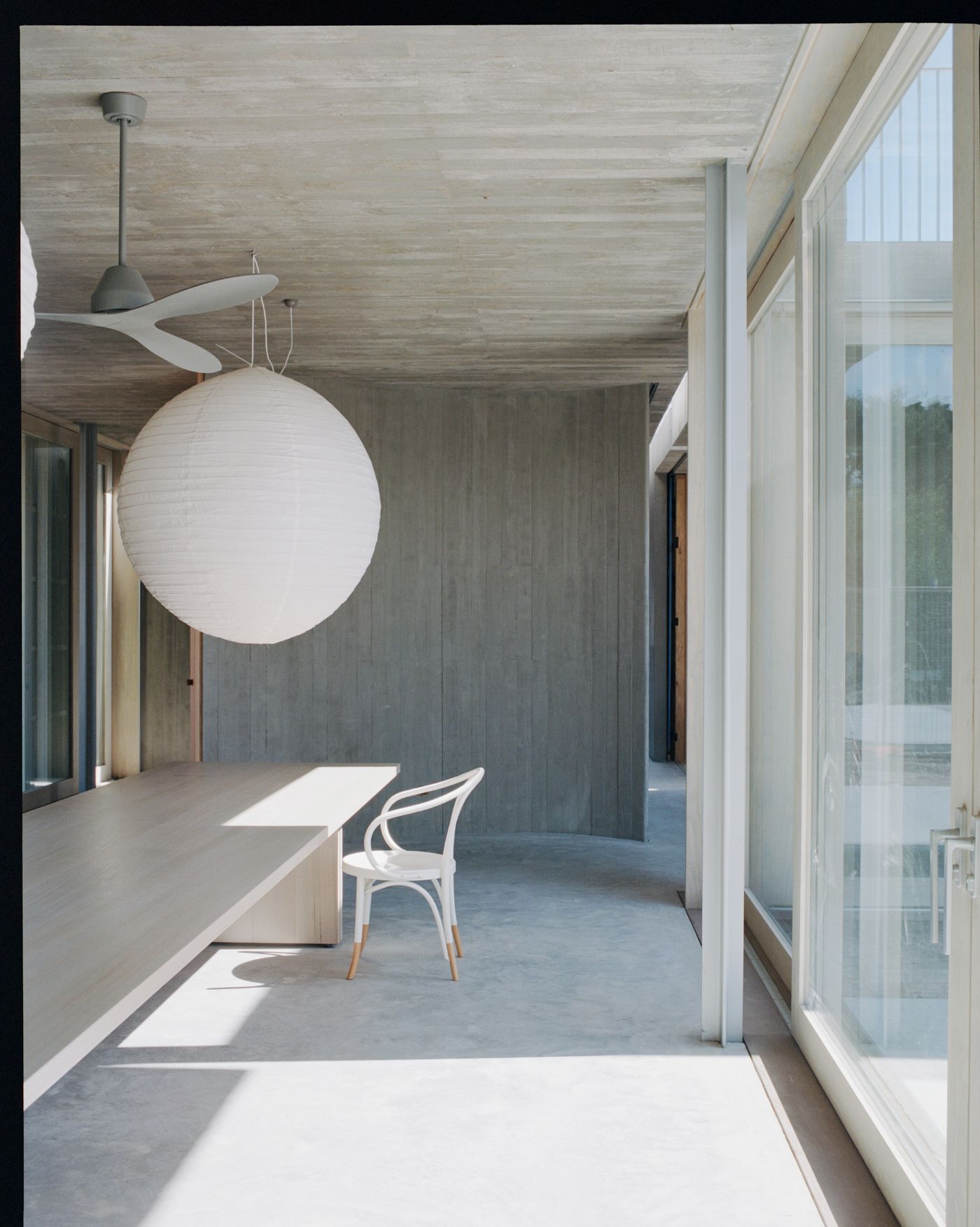 Mori House by Aires Mateus + MAArchitects — A dining passage in Mori House presents a refined material study in restraint.