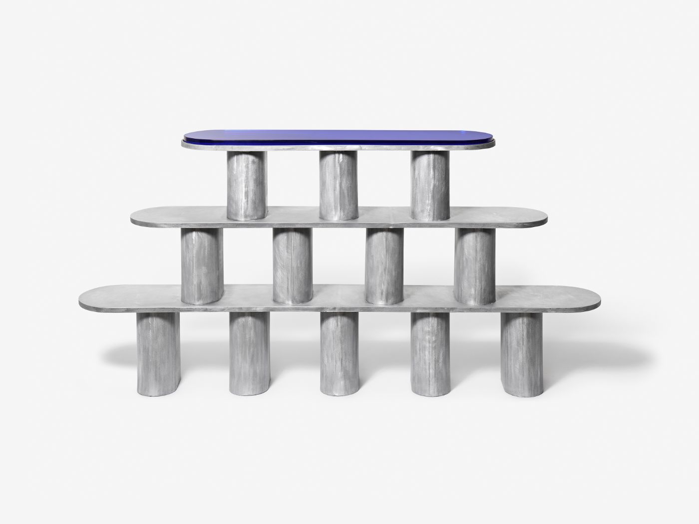 'Structure For Use' by Jeonghwa Seo — A modular shelving structure composed of five cast concrete cylindrical legs supporting three horizontal surfaces.