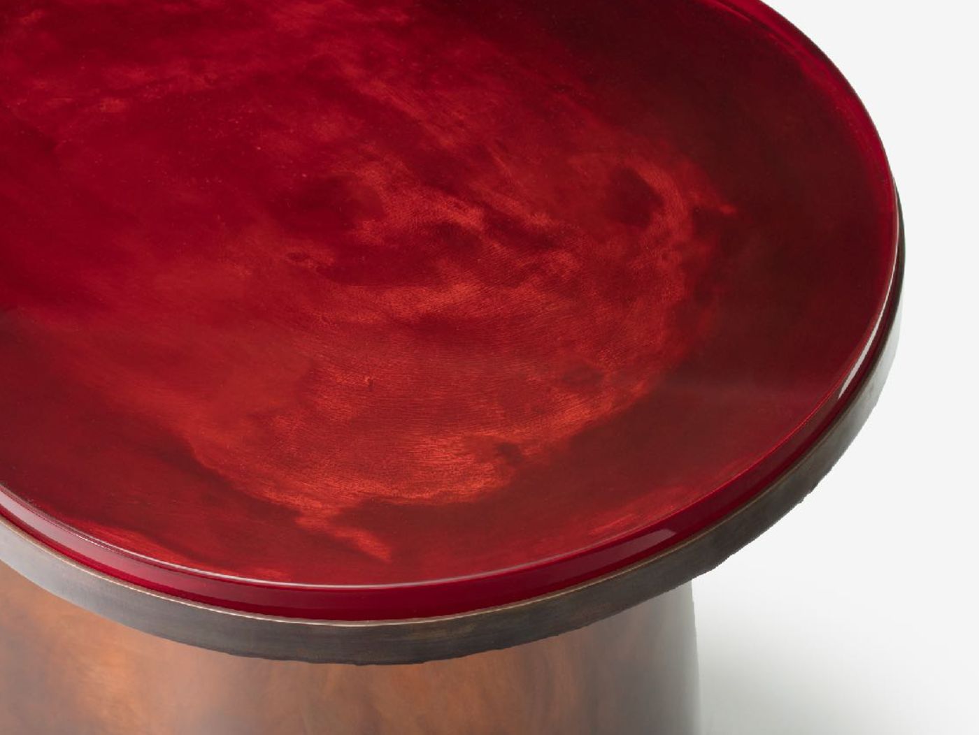 'Structure For Use' by Jeonghwa Seo — A close-up detail of a seating object from Seo's Structure For Use series, capturing the junction between a deep crimson-red cast resin or lacquered top...