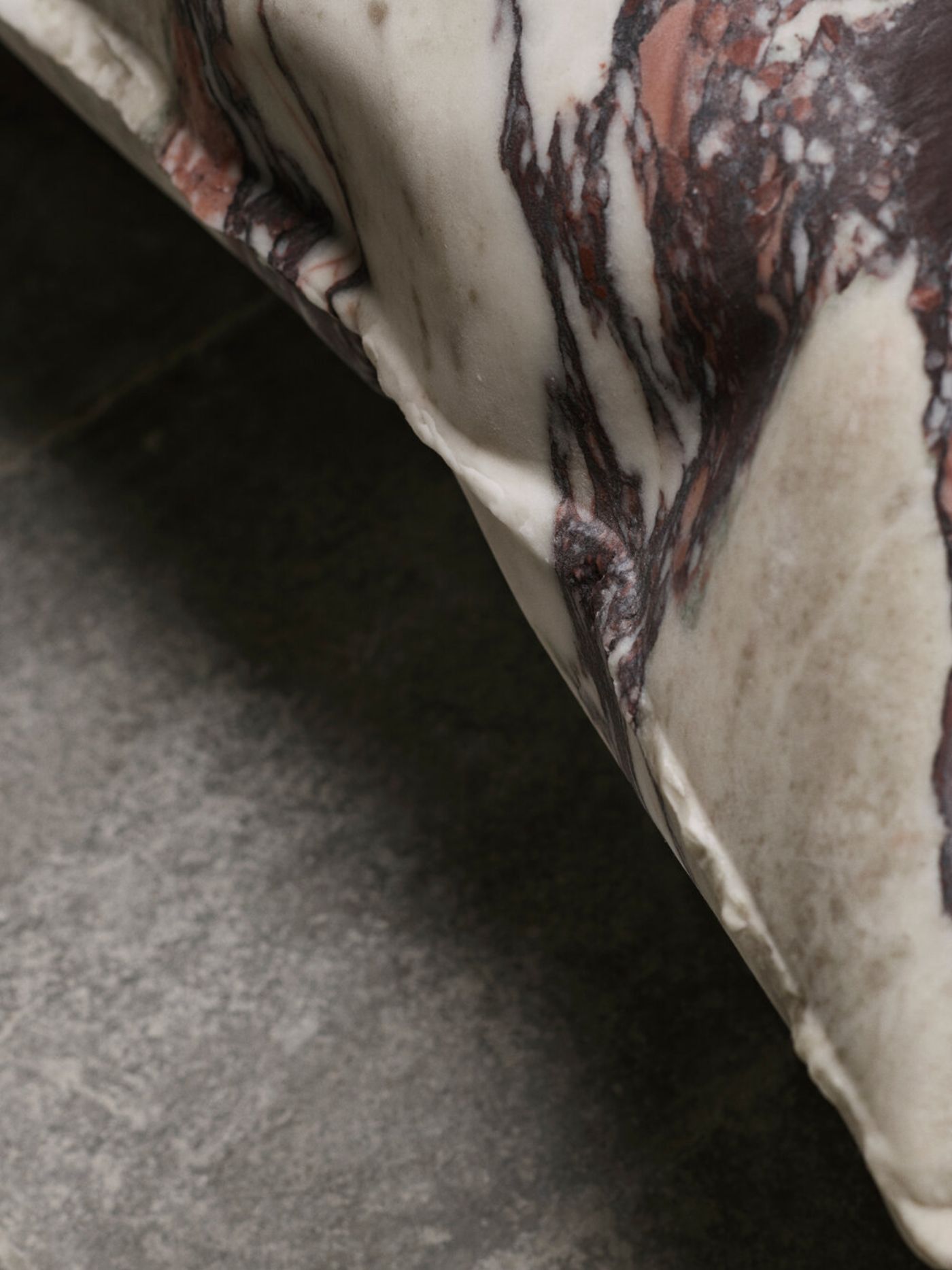 In Hale Wallpiece by Ben Storms — Close-up detail of inflated stainless steel wallpiece revealing the material's dual nature: rigid metal surface transformed into soft, cushion-like bulges...