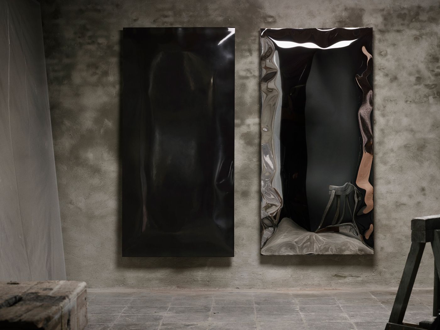 In Hale Wallpiece by Ben Storms — Two inflated metal wall pieces by Ben Storms occupy a concrete interior, their surfaces catching overhead light to reveal the complex geometry of their...