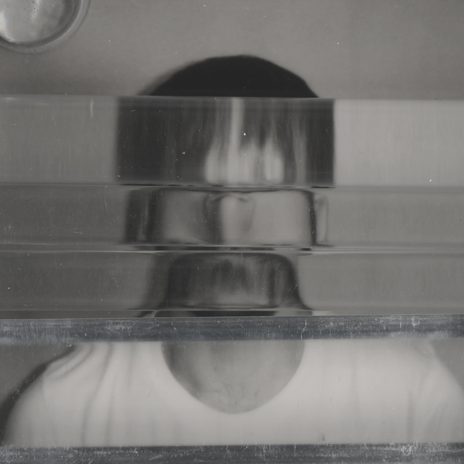Privacy Portraits by Operator — A portrait fragmented by vertical ribbed glass positioned between camera and subject, creating parallel linear distortions across the frame.