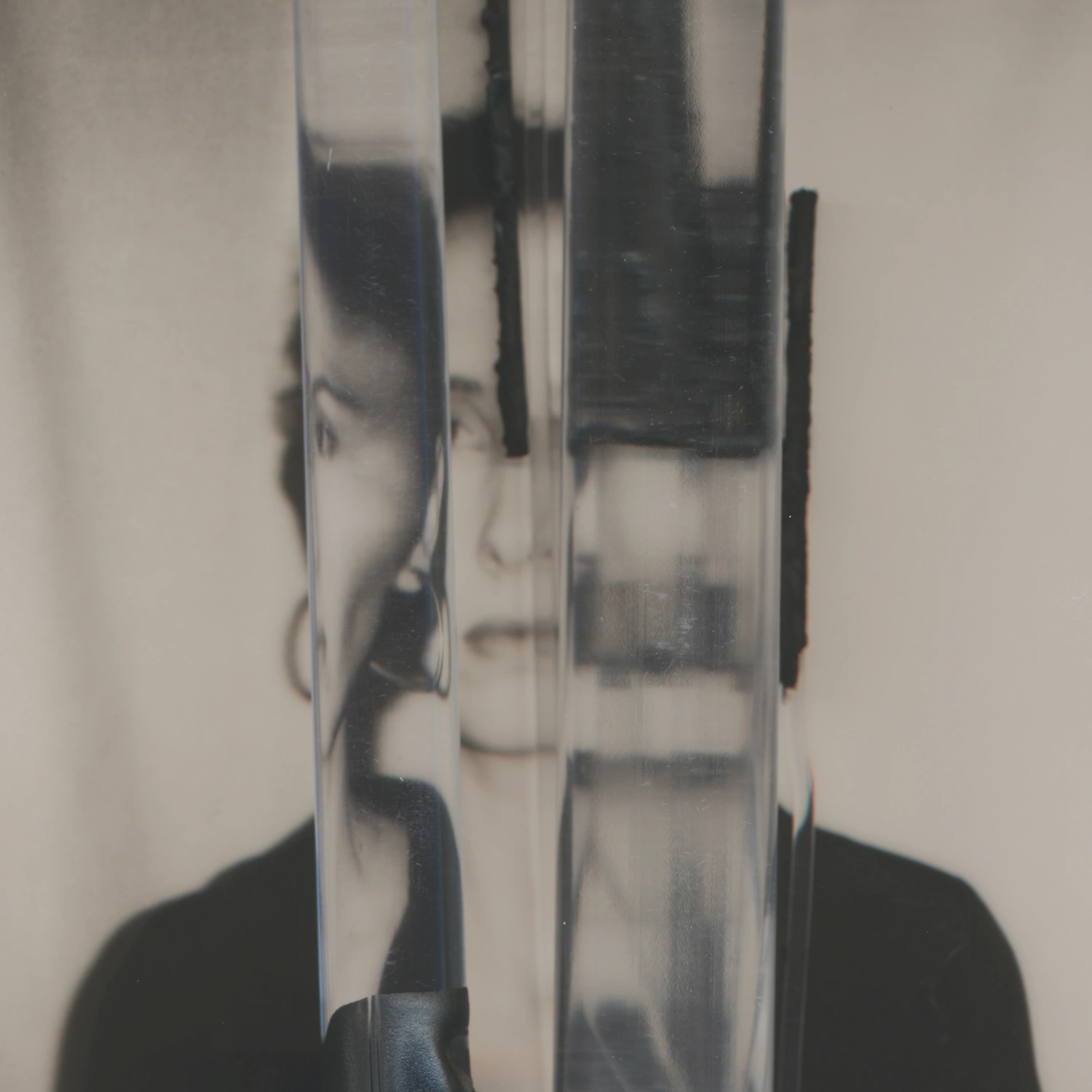 Privacy Portraits by Operator — A portrait fragmented by vertical ribbed glass, creating parallel linear distortions across the subject's face.