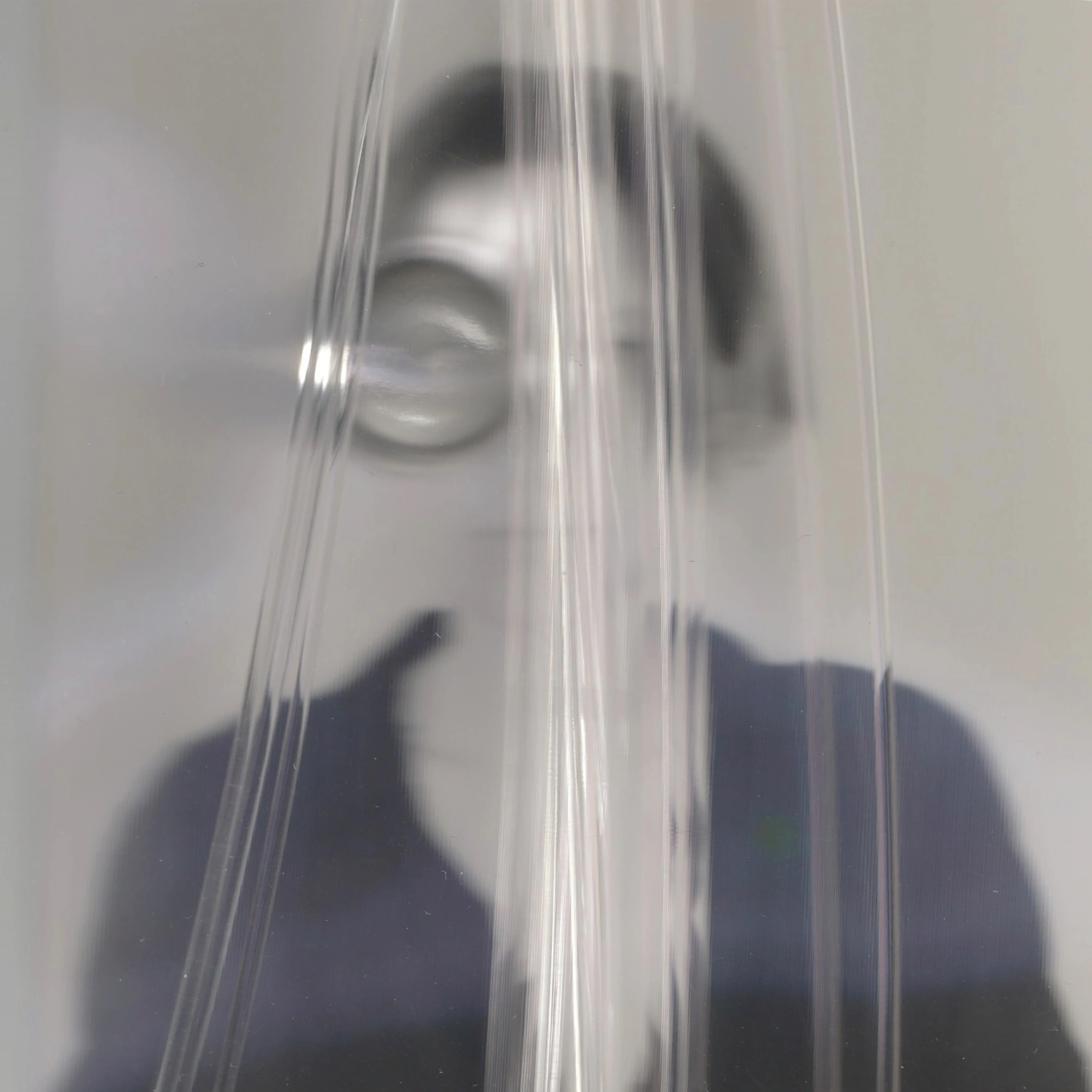 Privacy Portraits by Operator — A portrait obscured by vertical ribbed glass positioned directly in front of the camera lens.