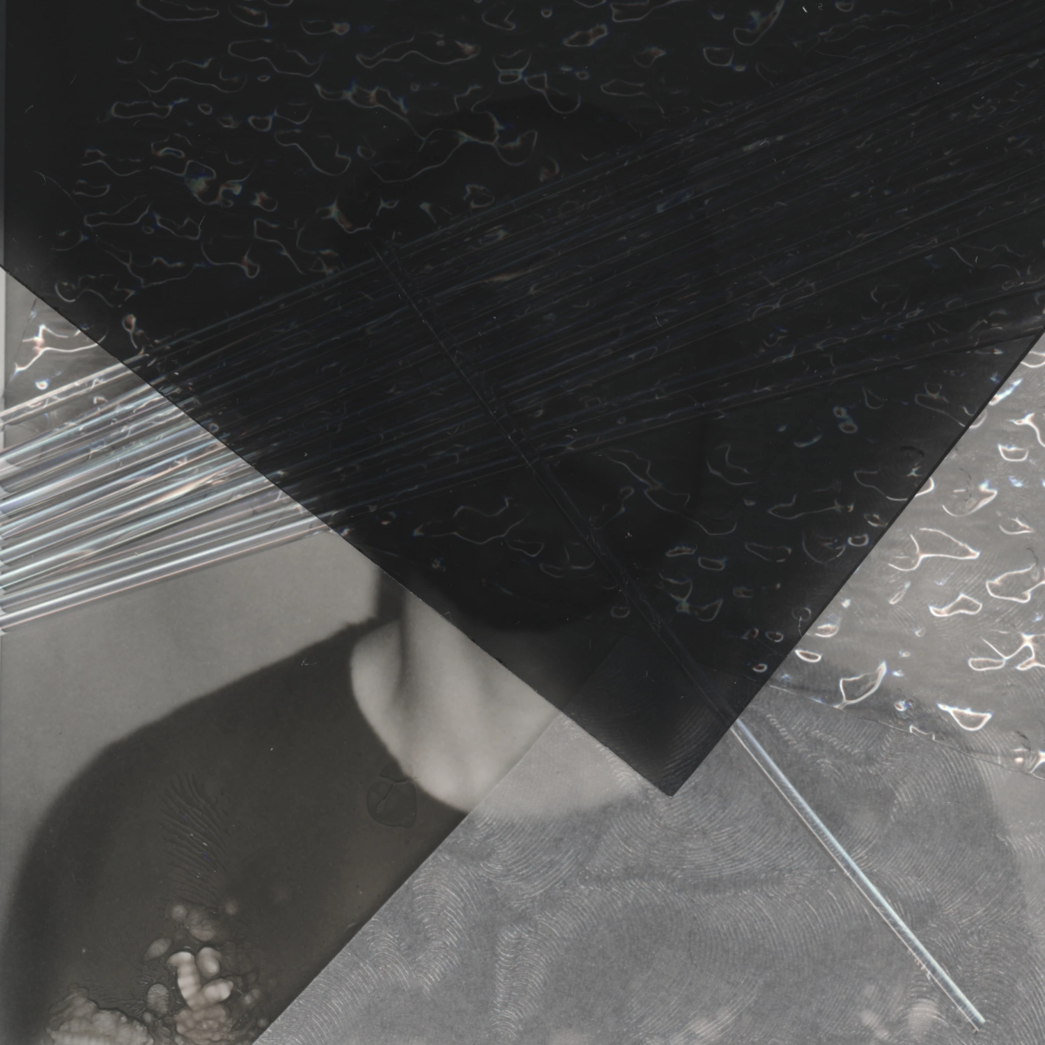 Privacy Portraits by Operator — A portrait obscured by vertical ribbed glass positioned directly before the camera lens, fragmenting the sitter's face into parallel linear distortions.