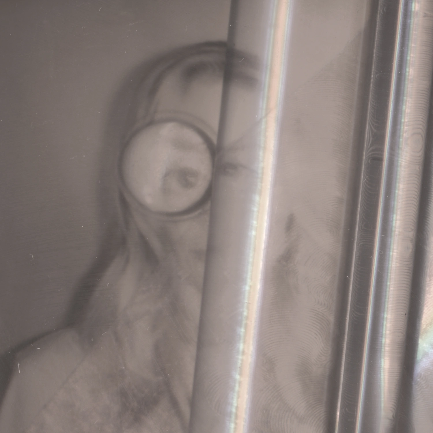 Privacy Portraits by Operator — A portrait rendered nearly unidentifiable through vertical ribbed glass positioned between camera and subject.