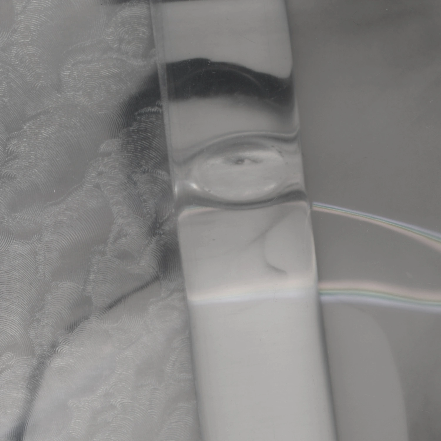 Privacy Portraits by Operator — A portrait obscured by a vertical ribbed glass panel positioned close to the camera, creating parallel linear distortions across the subject's face.