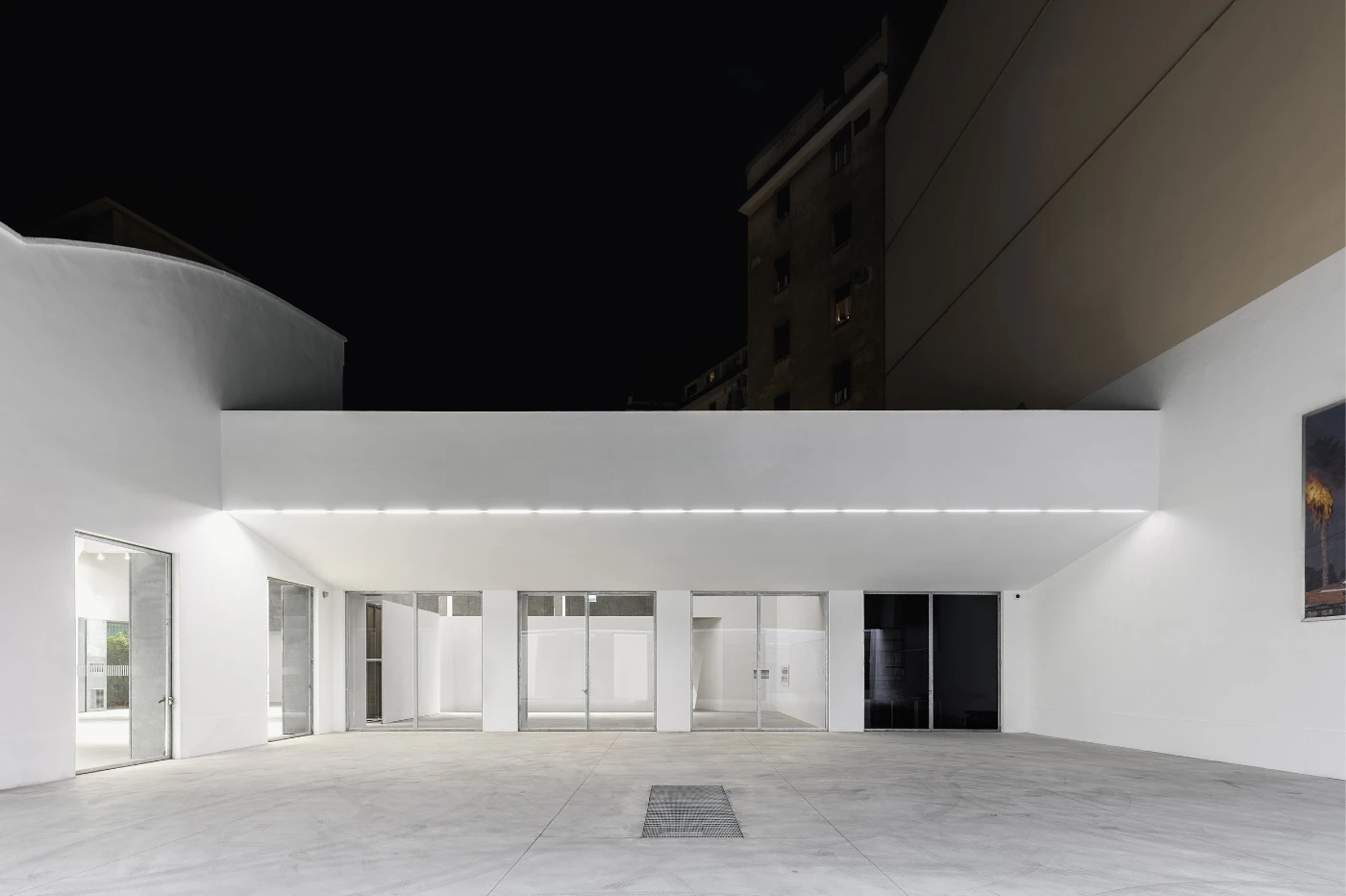 Spazio Maiocchi in Milan — A spacious ground-floor gallery within the former industrial building, defined by a monolithic white ceiling plane that hovers above the rectilinear volume.