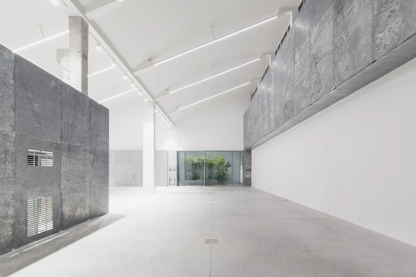 Spazio Maiocchi in Milan — A linear corridor within the renovated industrial space, defined by contrasting material zones.