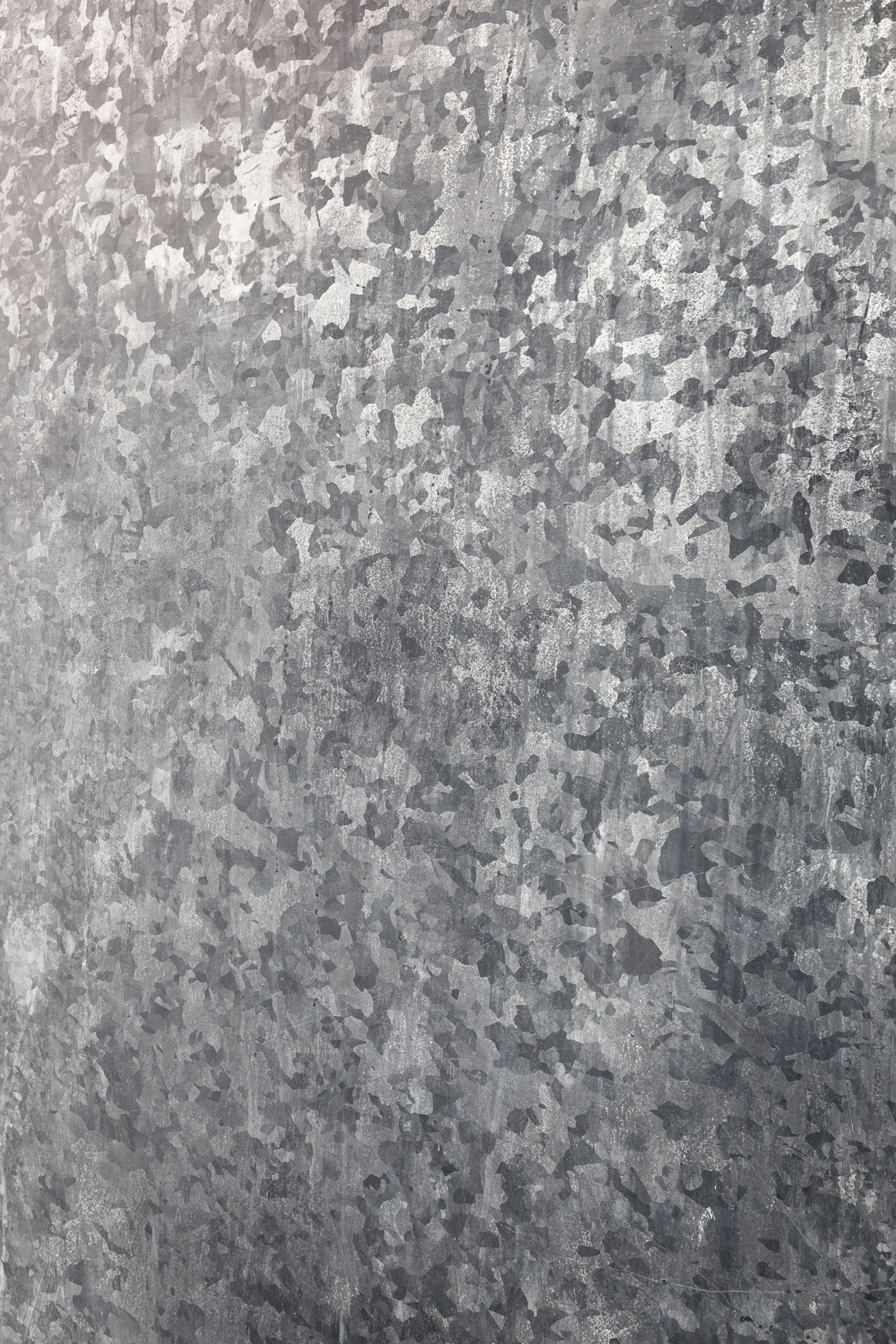 Spazio Maiocchi in Milan — Close-up detail of Spazio Maiocchi's textured wall surface, revealing the mottled finish of render or plaster in shades of grey and charcoal.