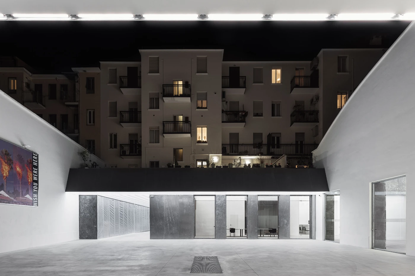 Spazio Maiocchi in Milan — A subterranean passage frames the residential courtyard above through a monumental aperture.