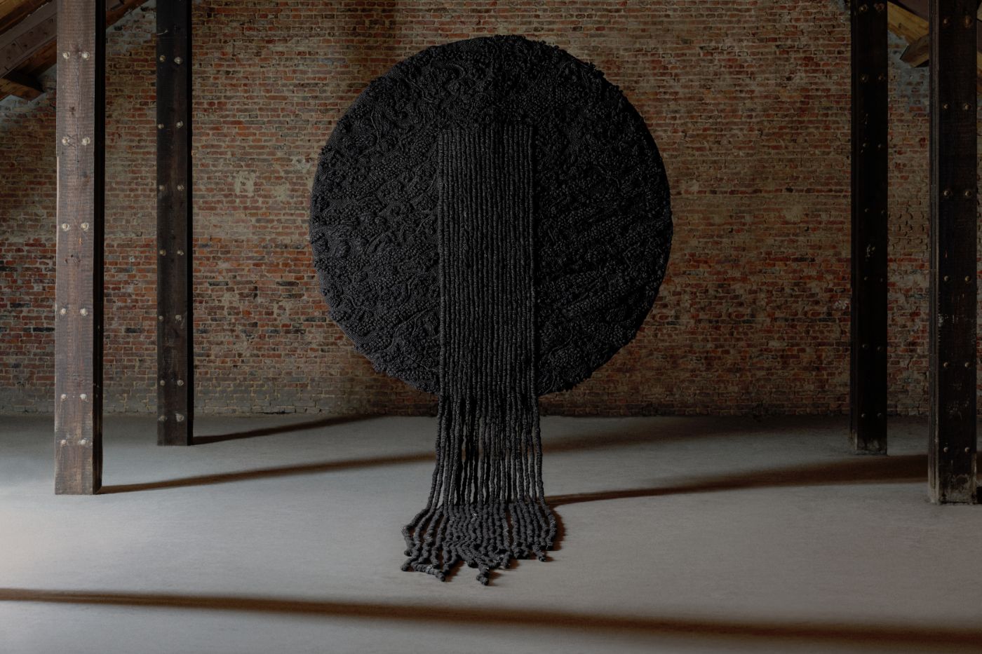 Limited collection by Victoria Yakusha — Hand-woven textile sculpture depicting a stylized tree form constructed from charcoal-toned fibers.