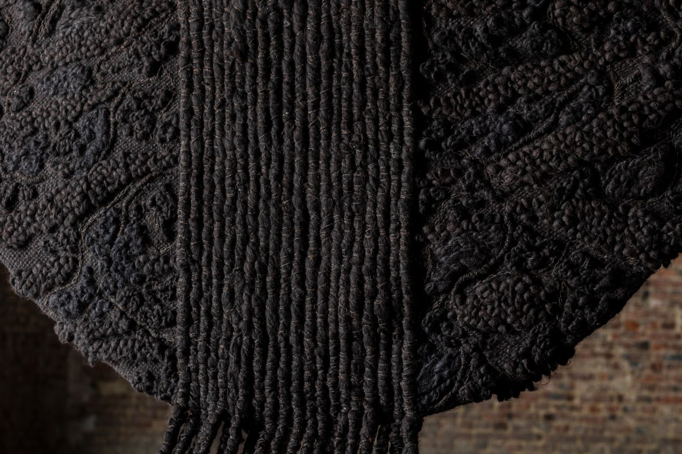 Limited collection by Victoria Yakusha — Close-up detail of the Zemlia hand-woven tapestry reveals the textile's construction and material specificity.