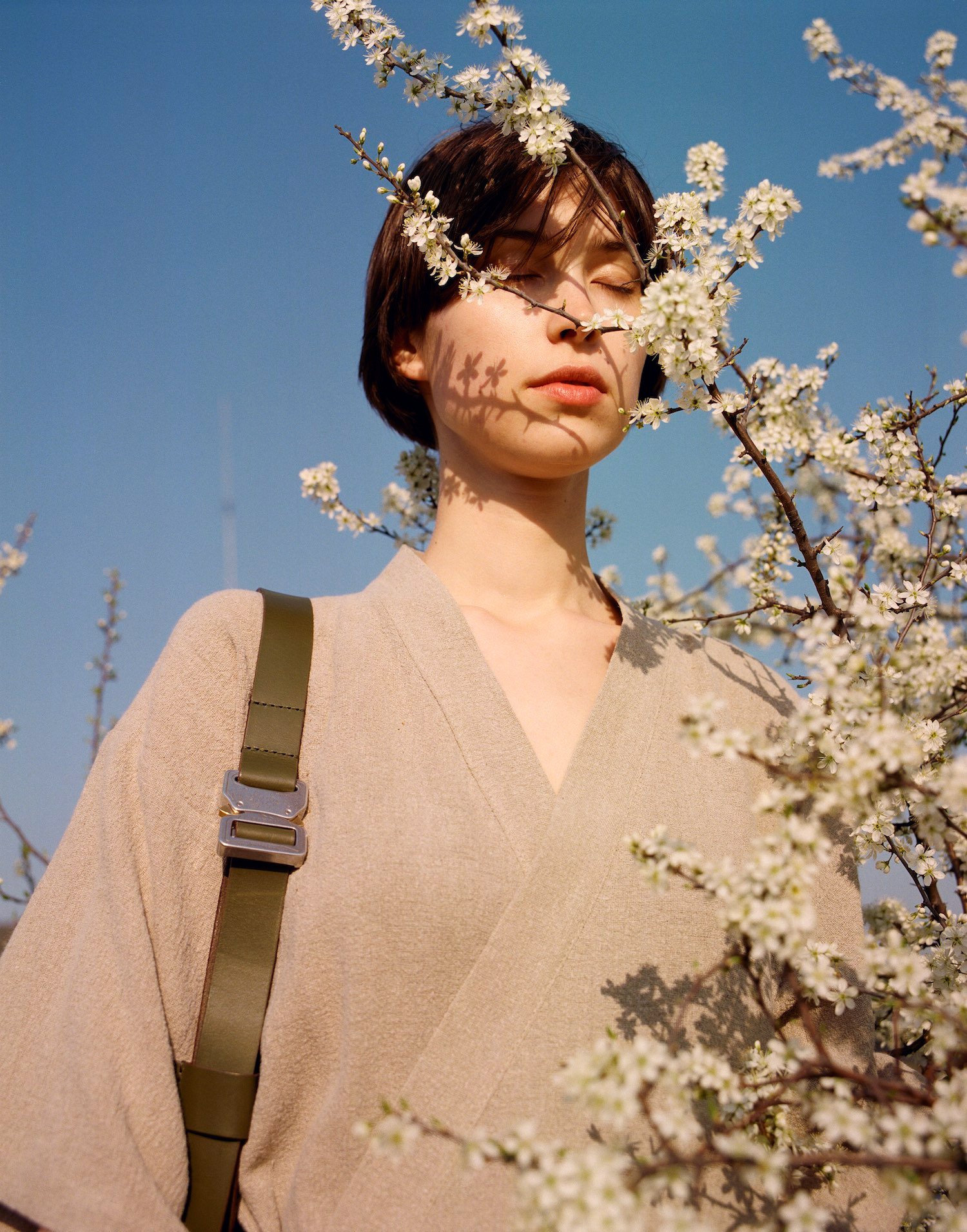Thisispaper Bags & Backpacks Collection by Thisispaper Studio — A portrait from the Thisispaper Bags & Backpacks Collection featuring a model wearing a cream-colored knit cardigan with V-neckline and an olive-toned...
