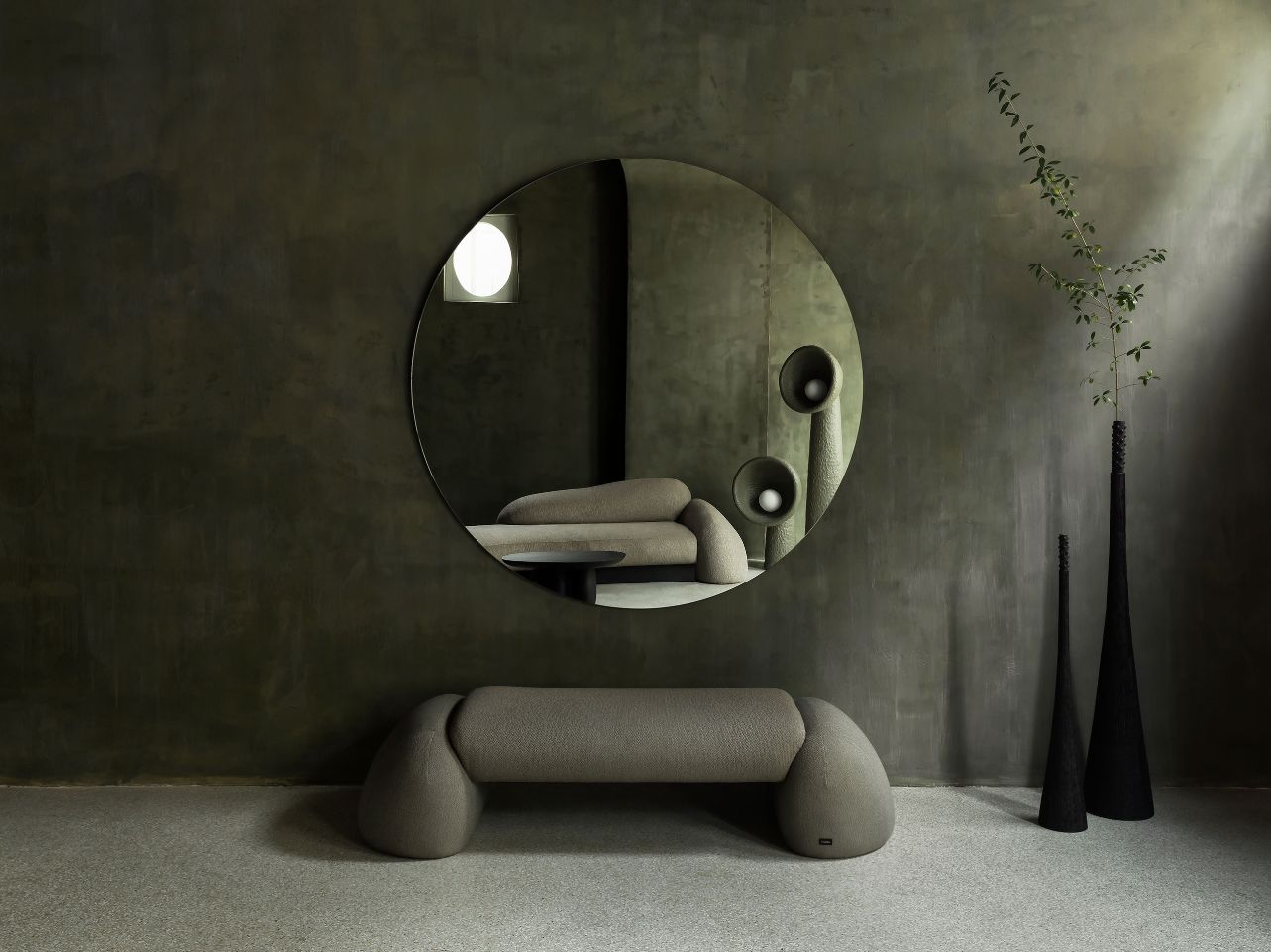 Faina Gallery by Yakusha Studio — A sculptural arrangement within Faina Gallery's restored interior showcases a curved cream-linen sofa positioned centrally on polished concrete flooring.