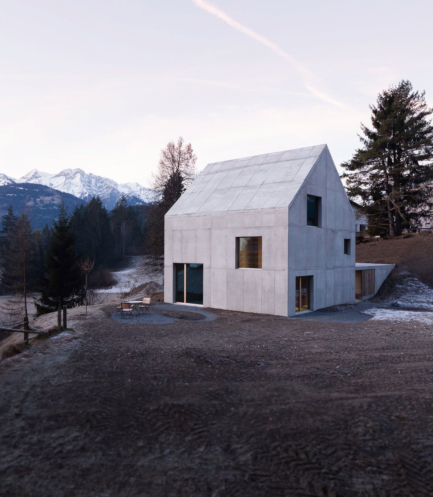 The Trin Cabin By Schneller Caminada Architects — Schneller Caminada's Trin Cabin presents a three-story rectilinear volume clad in light concrete with locally-sourced pigmentation.