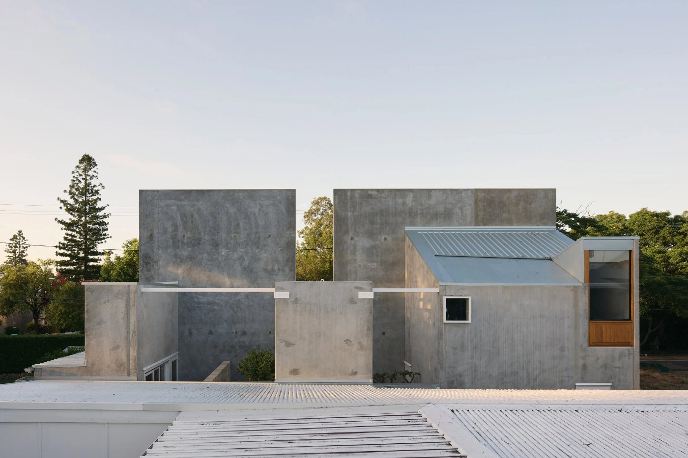 Chelmer River House by Furminger by Christopher Furminger — Chelmer River House presents its frontal garden-facing elevation as a composition of monolithic concrete panels of varying heights, their weathered surfaces...
