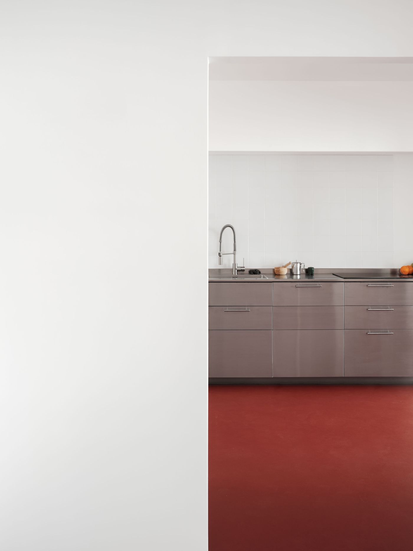 Lara House by HANGHAR — Kitchen detail from Lara House reveals a material and chromatic strategy of deliberate contrast.