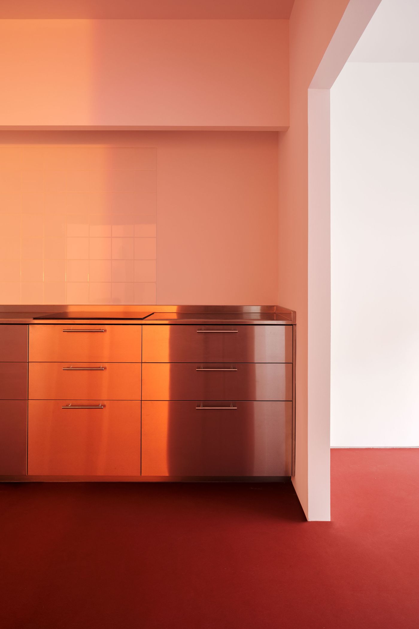 Lara House by HANGHAR — A monochromatic orange interior defined by volumetric color saturation across walls, ceiling, and floor.
