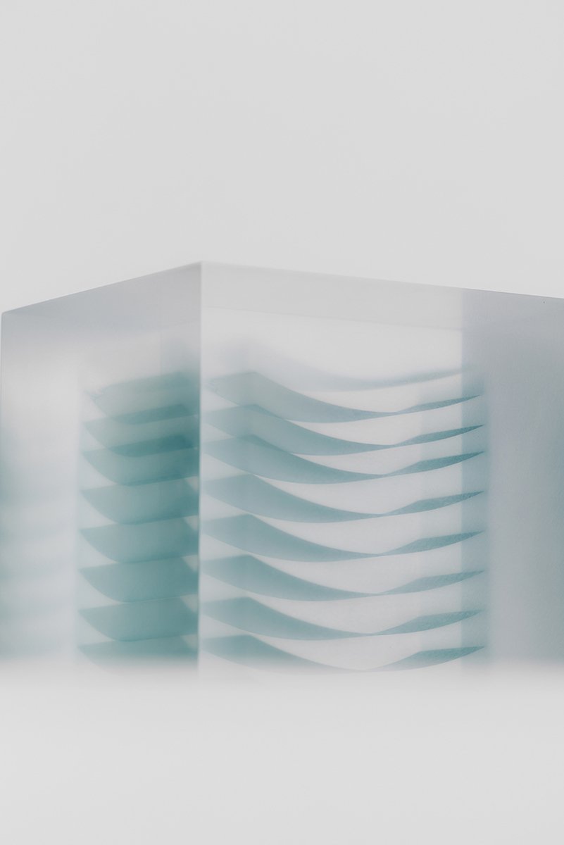 Block Series by Rahee Yoon — A transparent acrylic sculptural block containing layered teal-colored material arranged in horizontal strata.