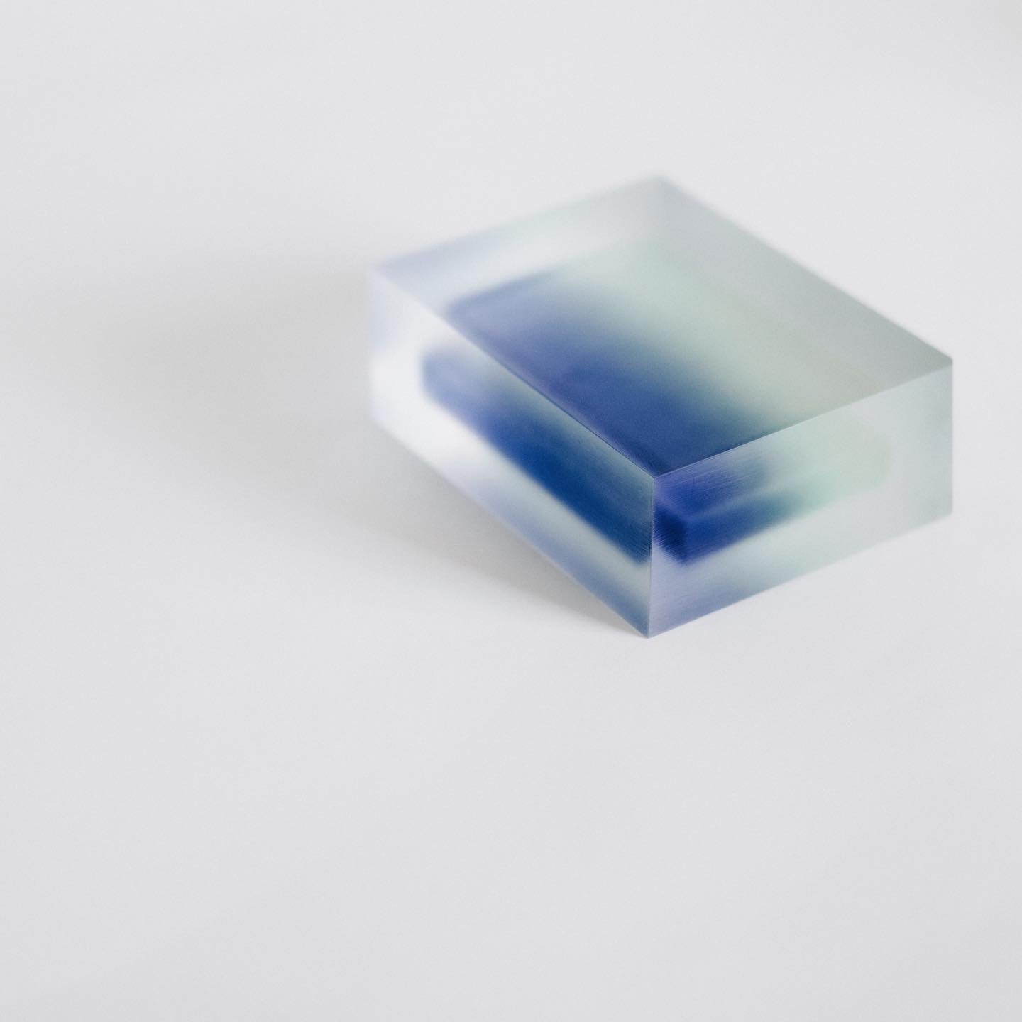 Block Series by Rahee Yoon — A transparent acrylic block sculpture containing a suspended rectangular form rendered in deep blue gradient material.