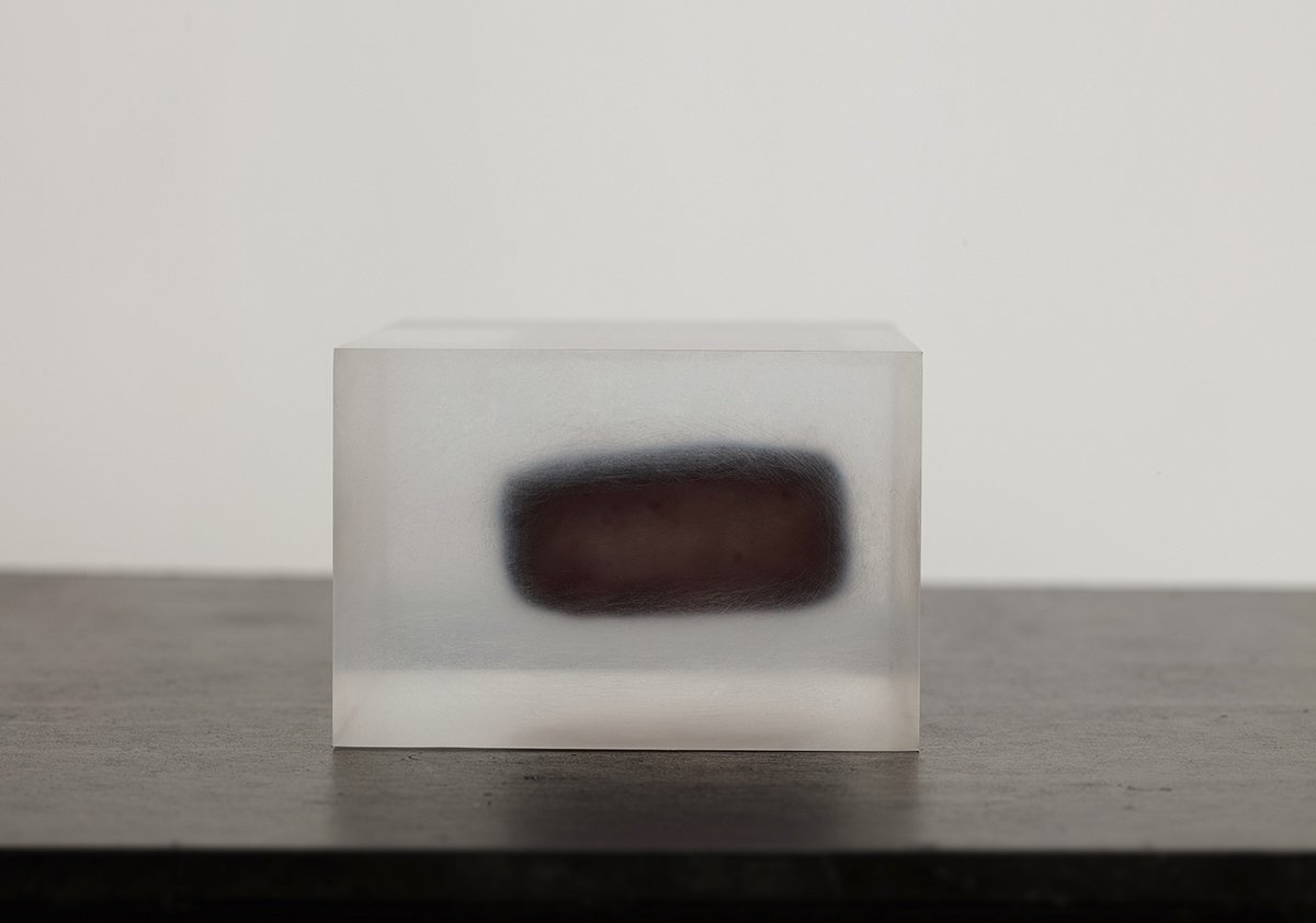 Block Series by Rahee Yoon — A translucent acrylic block positioned on a gray surface against a neutral backdrop.