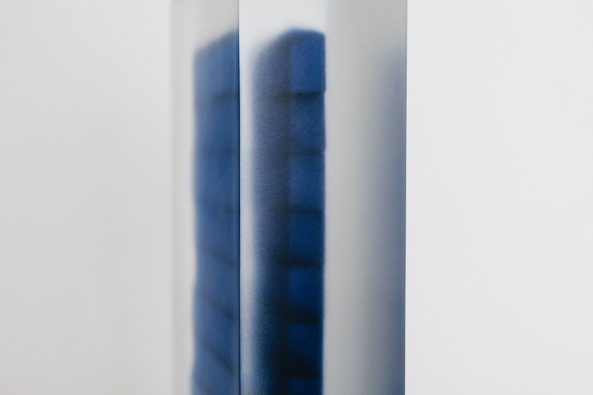 Block Series by Rahee Yoon — A vertical acrylic block sculpture from Rahee Yoon's Block Series featuring a dark blue rectangular form suspended within transparent material.