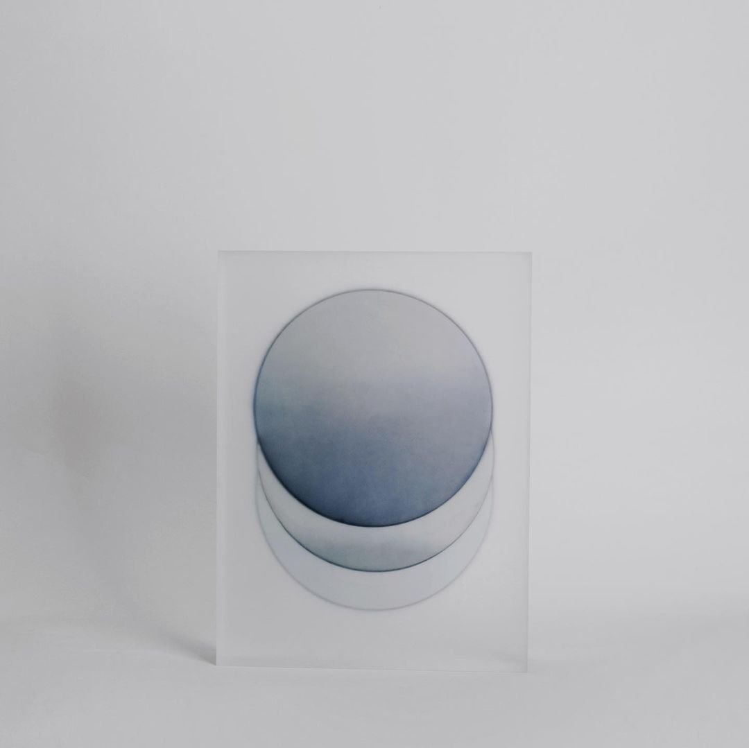 Block Series by Rahee Yoon — A white acrylic block with frosted interior surfaces contains a dark spherical form that appears suspended within the translucent material.