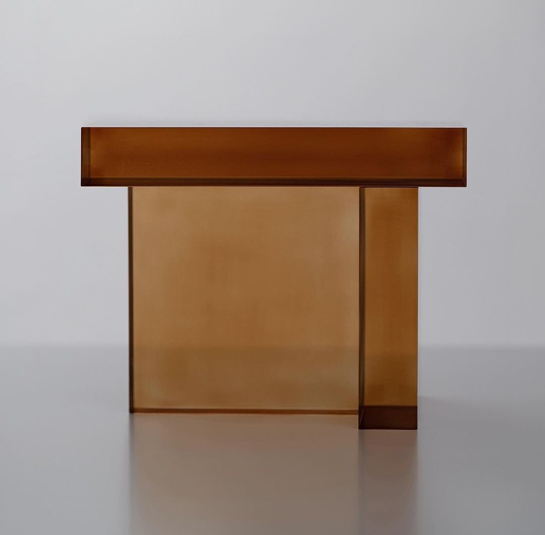 Block Series by Rahee Yoon — A geometric acrylic sculpture from Rahee Yoon's Block series features a translucent amber-toned block with frosted interior surfaces that create soft...