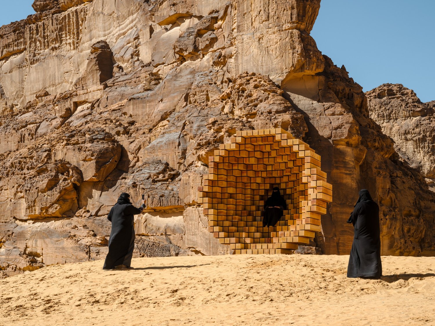 Desert X AlUla 2022 Group Exhibition — A monumental tiled installation occupies a natural cavity within an eroded sandstone cliff face in the AlUla desert.